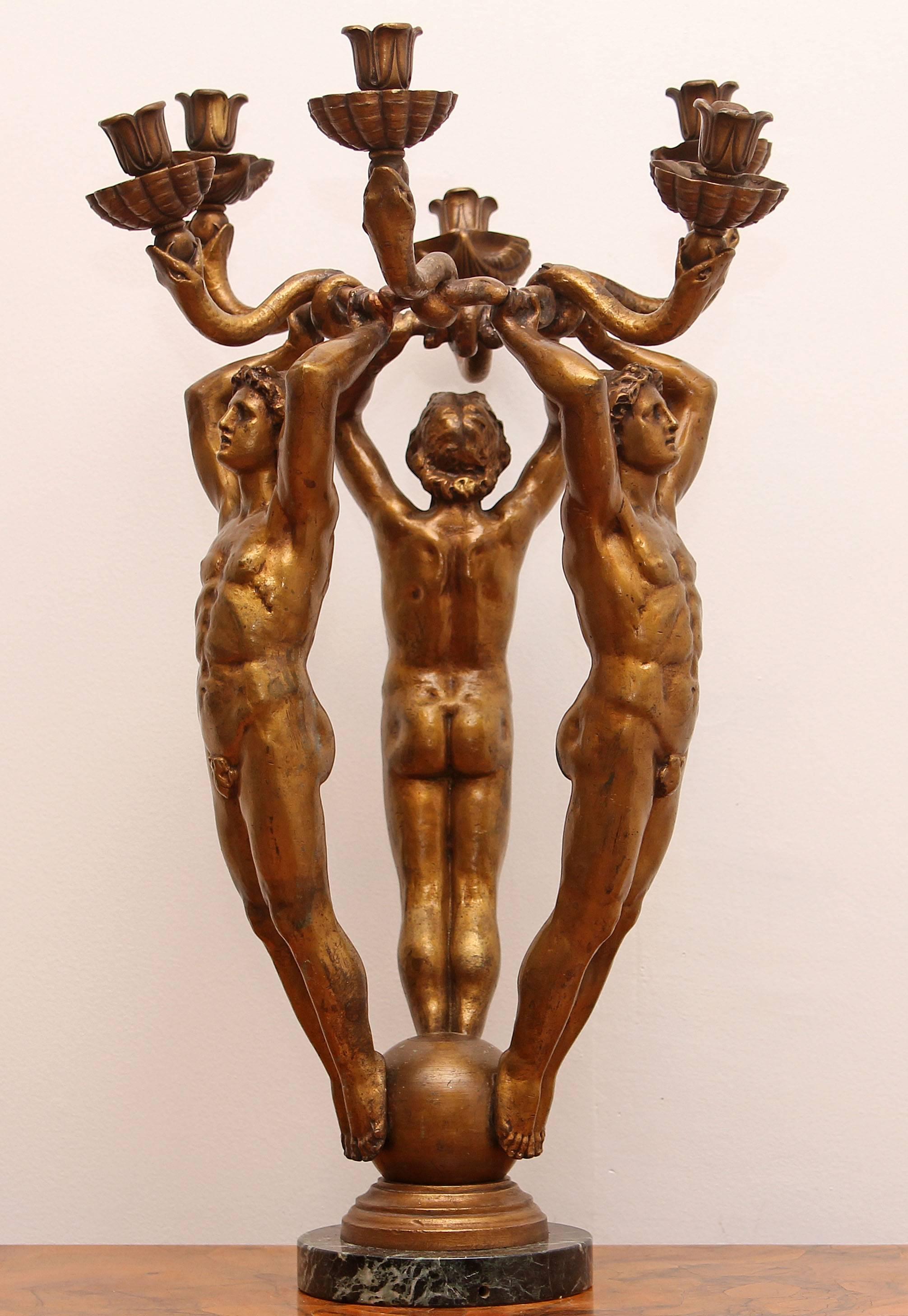 Large art deco antique bronze candelabra sculpture. Figural candelabra by E.F. Caldwell. Three nude male figures holding ring entwined with snakes. American classical revival.  circa 1920. 