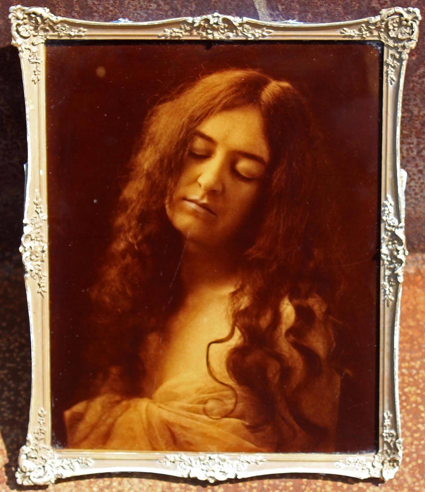 Antique vintage photograph of young woman. In the manner of Julia Margaret Cameron. Image is mounted on glass.