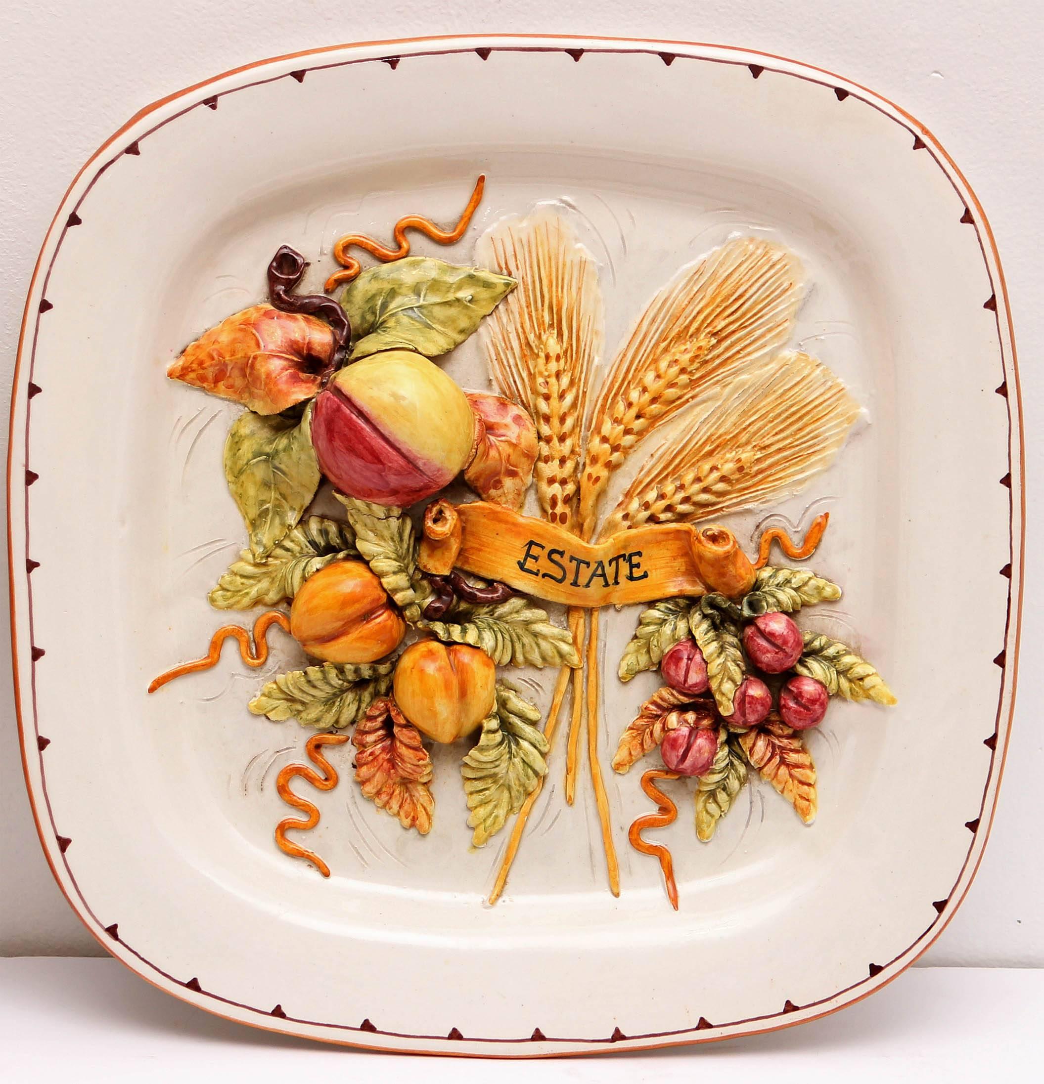 Colorful Italian majolica wall hung plaques representing the food of the four seasons.