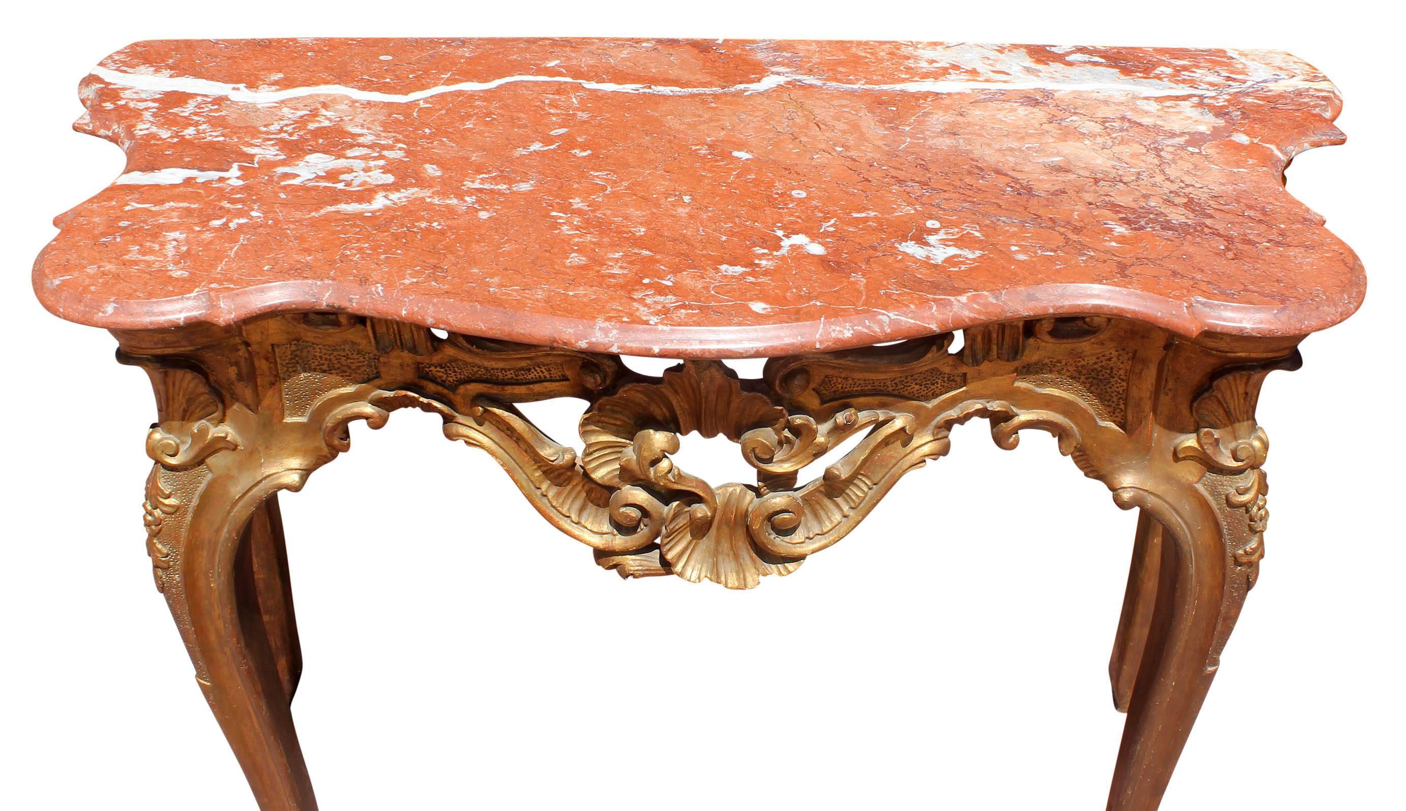 Antique carved and giltwood Italian Rococo console table. Variegated rouge marble top. Please, contact us for shipping options.