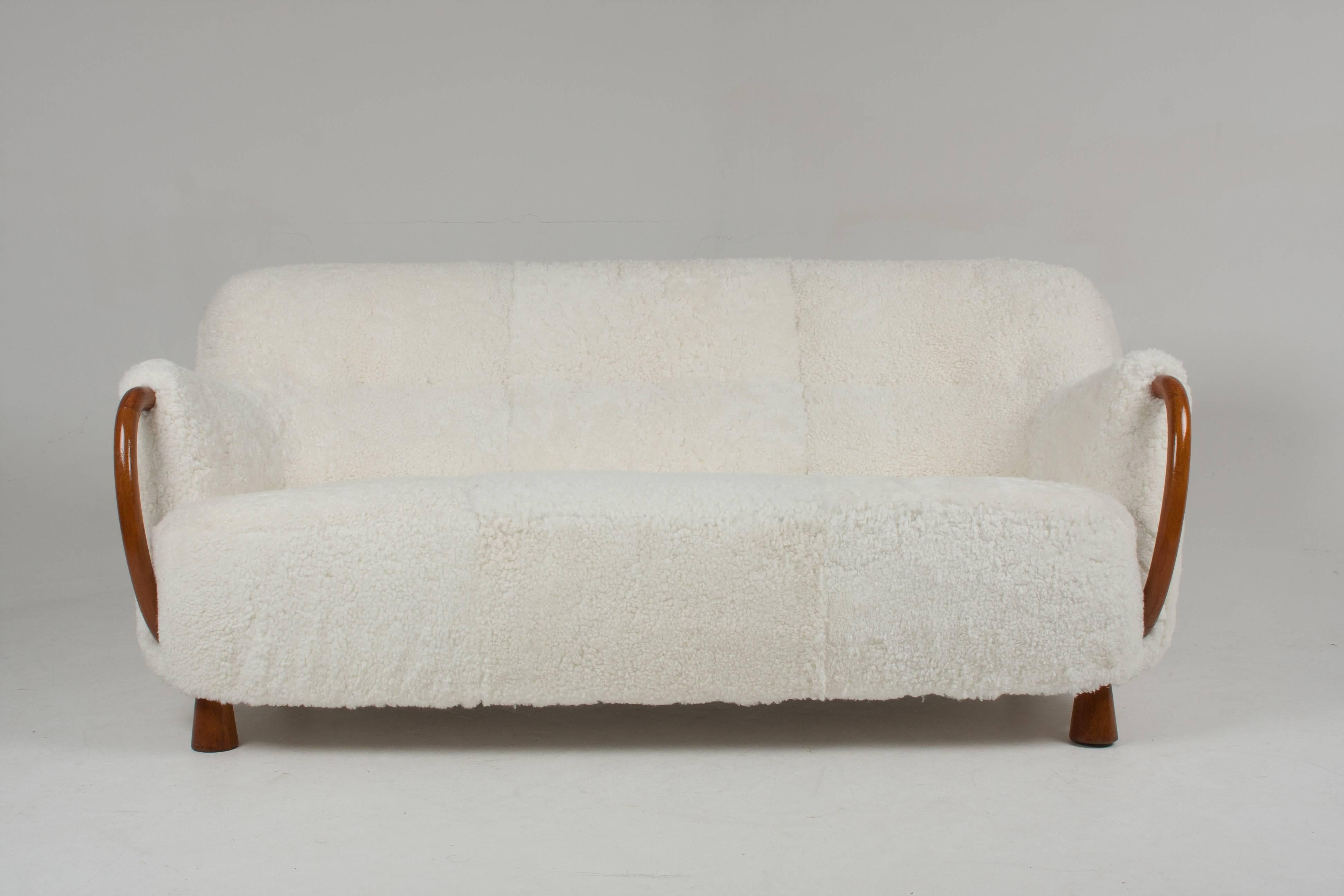 You are viewing a stunning Vintage three-seat Sofa with Sheepskin by Viggo Boesen for Slagelse Mobelvaerk

The sofa has been professionally re-upholstered in white sheepskin.

Oak arms and feet.

Designed by Viggo Boesen.

Similar depicted