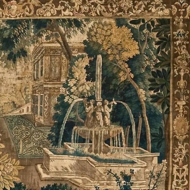 A flemish silk and wool tapestry depicting psyche and the sleeping cupid in the garden of a rural house with architectural fountain.
 
Probably Audenarde from the early 18th century.
 
The red cloak of psyche is particularly striking, as well as