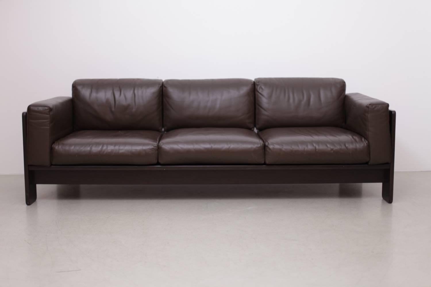 Very elegant combination in brown leather and dark stained wood. The leather shows some patina but the condition is really superb.