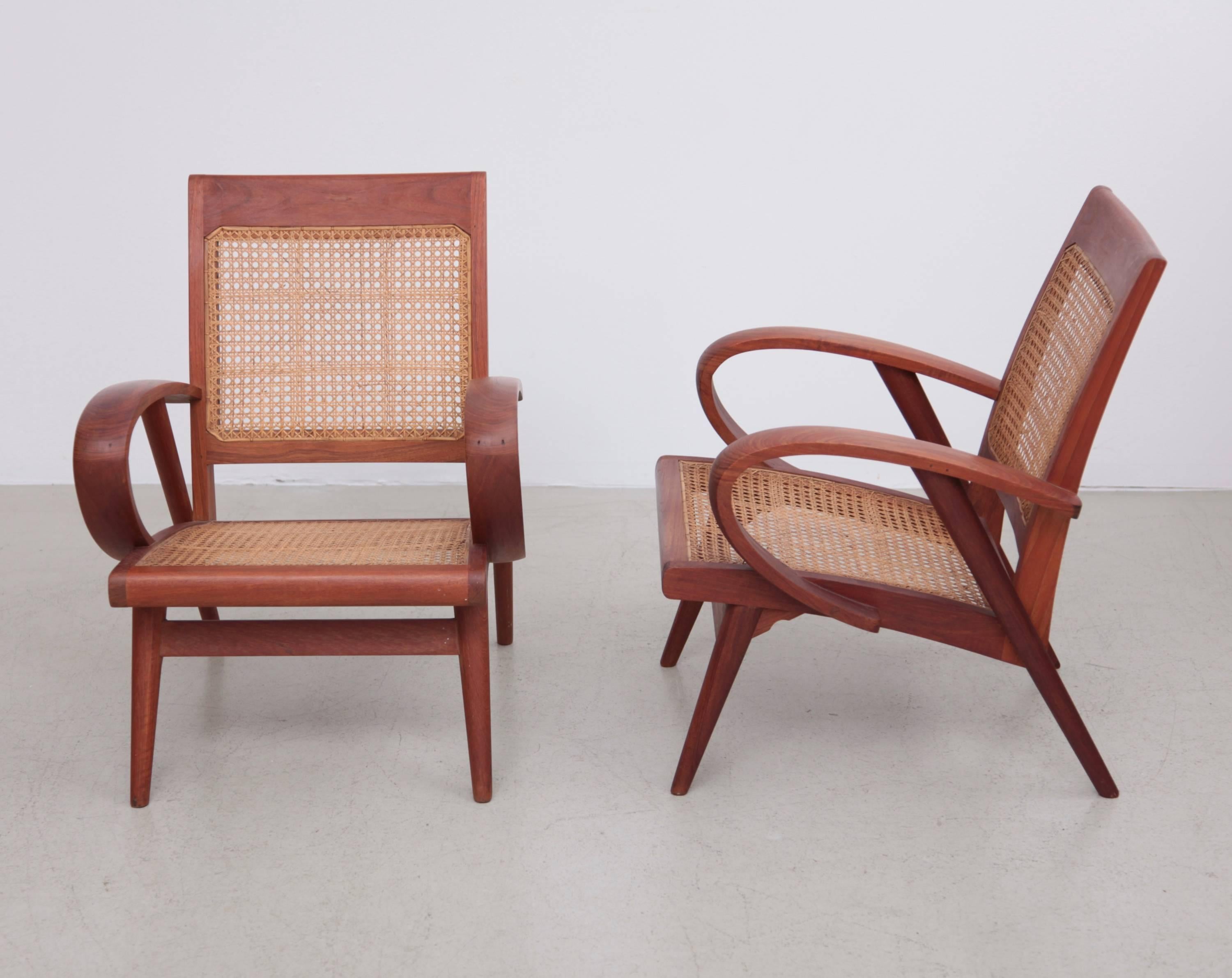 Absolute mint and elegant pair of Danish studio lounge chairs with cane back and seat. Stunning woodworking with only wooden connections.
