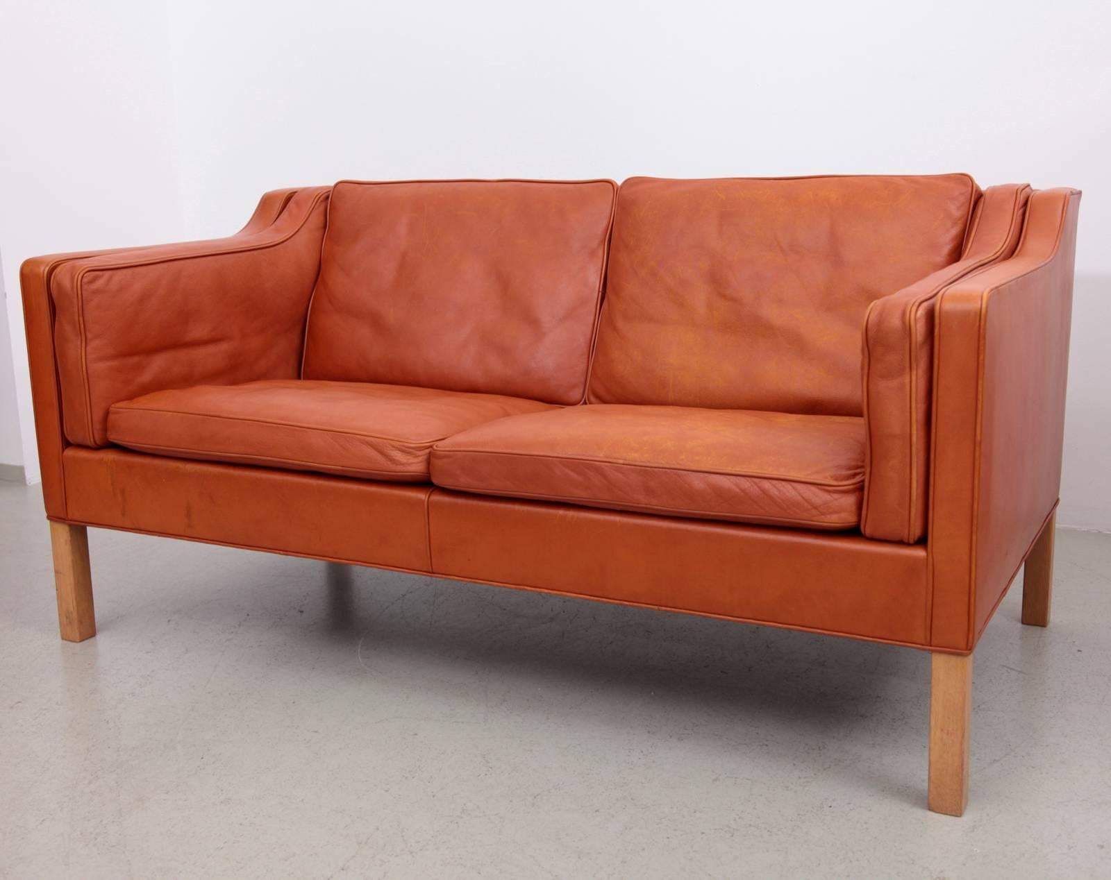 Fantastic early example of the Classic two-seat sofa designed by Børge Mogensen for Fredericia, Denmark, model 2213. This example in wonderful and super rare thick cognac leather with perfect vintage patina.