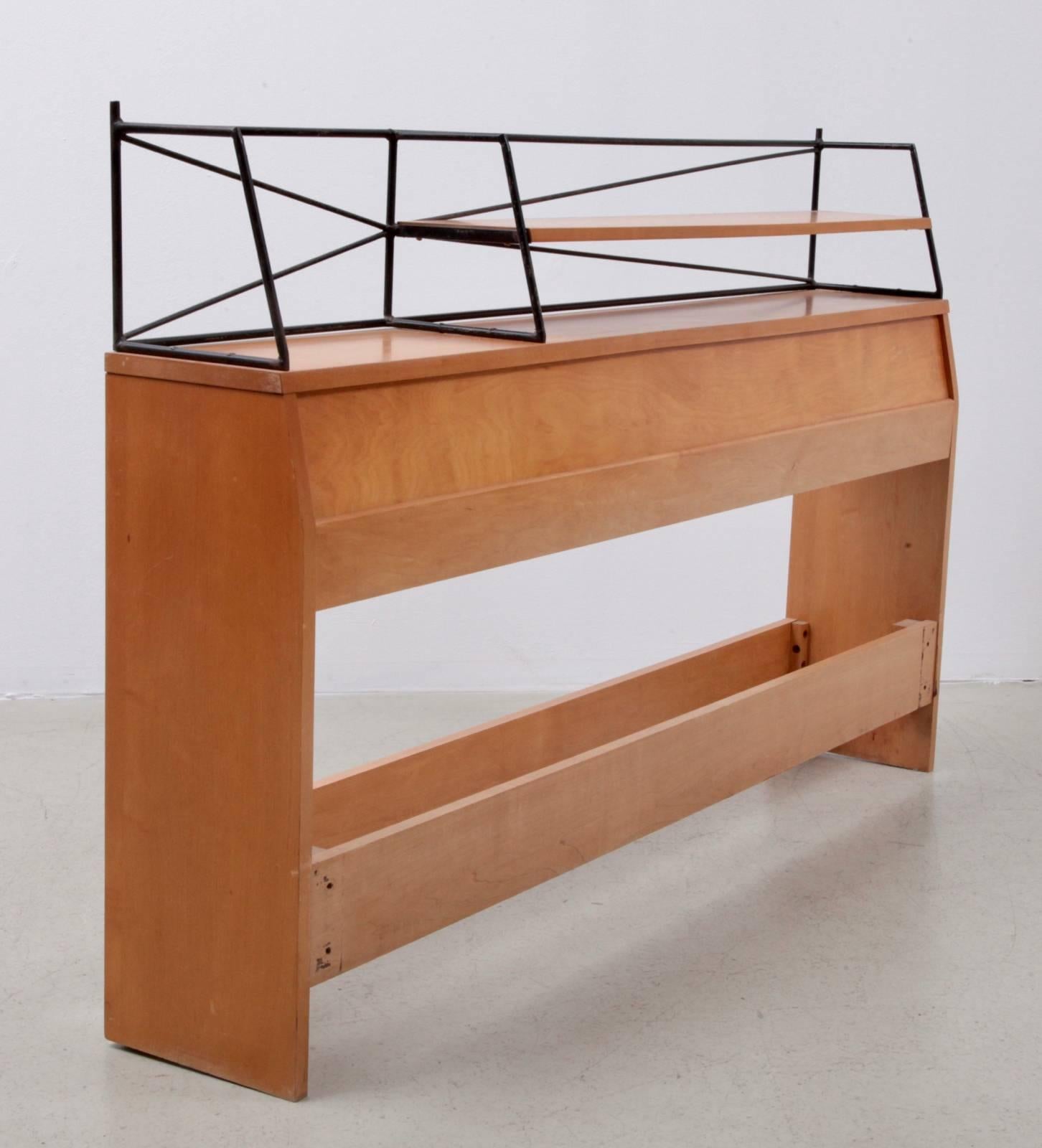 Rare wrought iron Paul McCobb headboard in solid maple. Signed and in very good condition.

