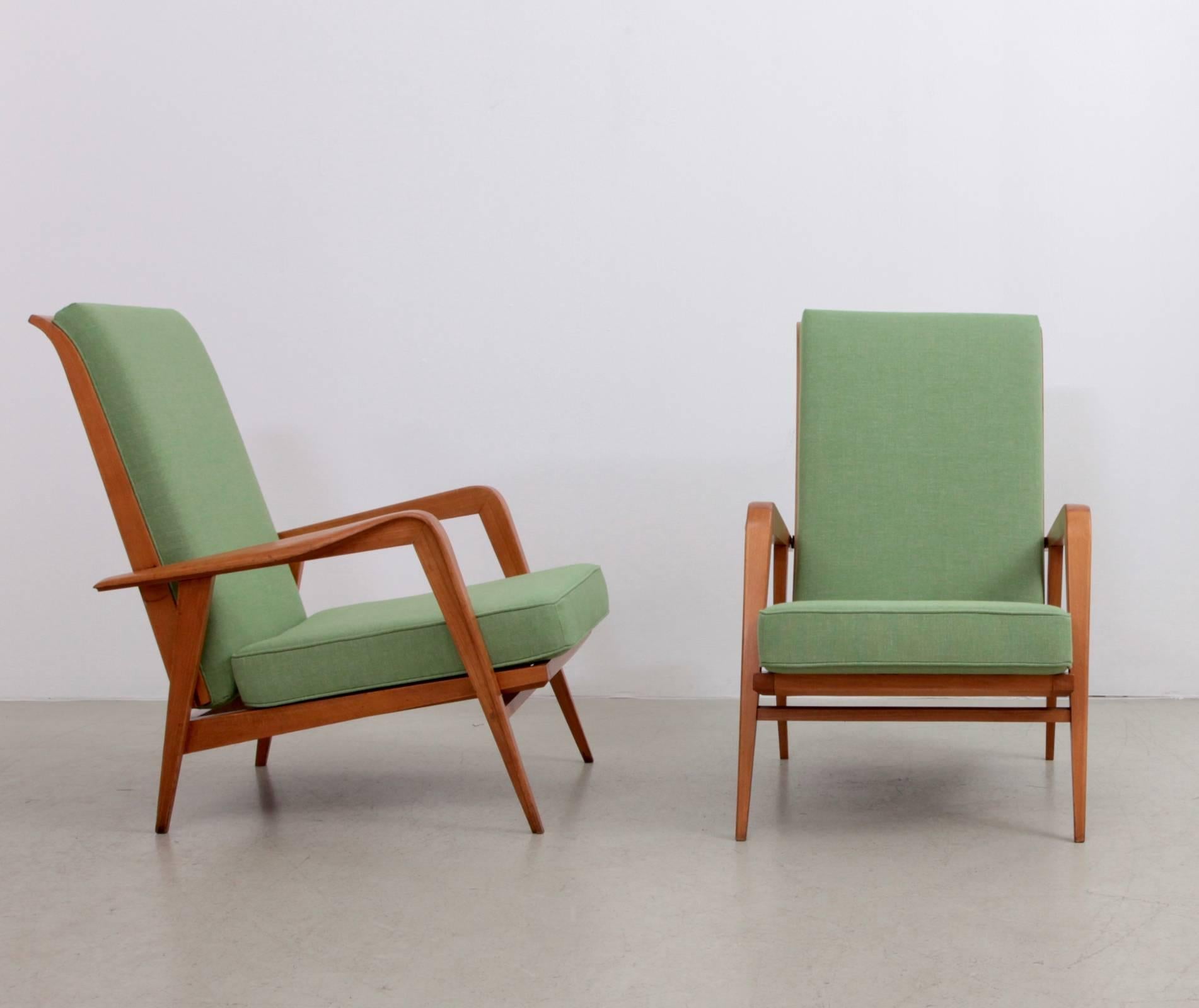 Pair of upholstered armchairs with solid beechwood frame by Etienne Henri Martin. These chairs have two different positions.

