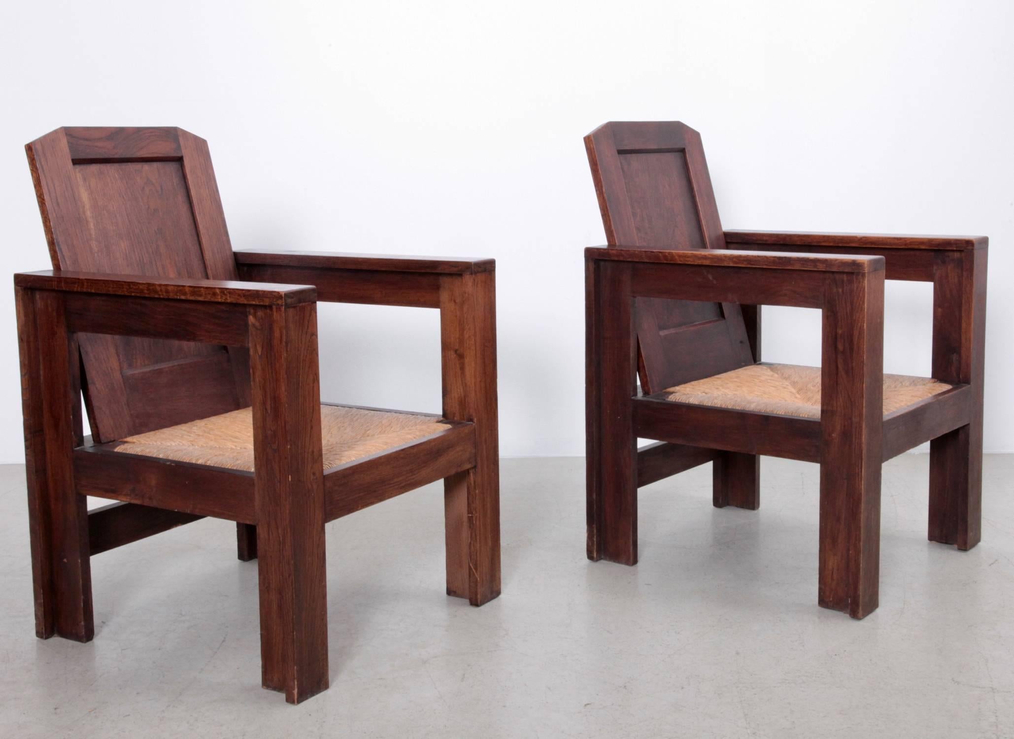 Rare excellent pair of Joseph Gavina lounge chairs in solid oak and grass webbing. Joseph Savina, (1901-1983), was a Breton woodworker, cabinet maker and sculptor who was a member of the art movement Seiz Breur. He collaborated with Le Corbusier on