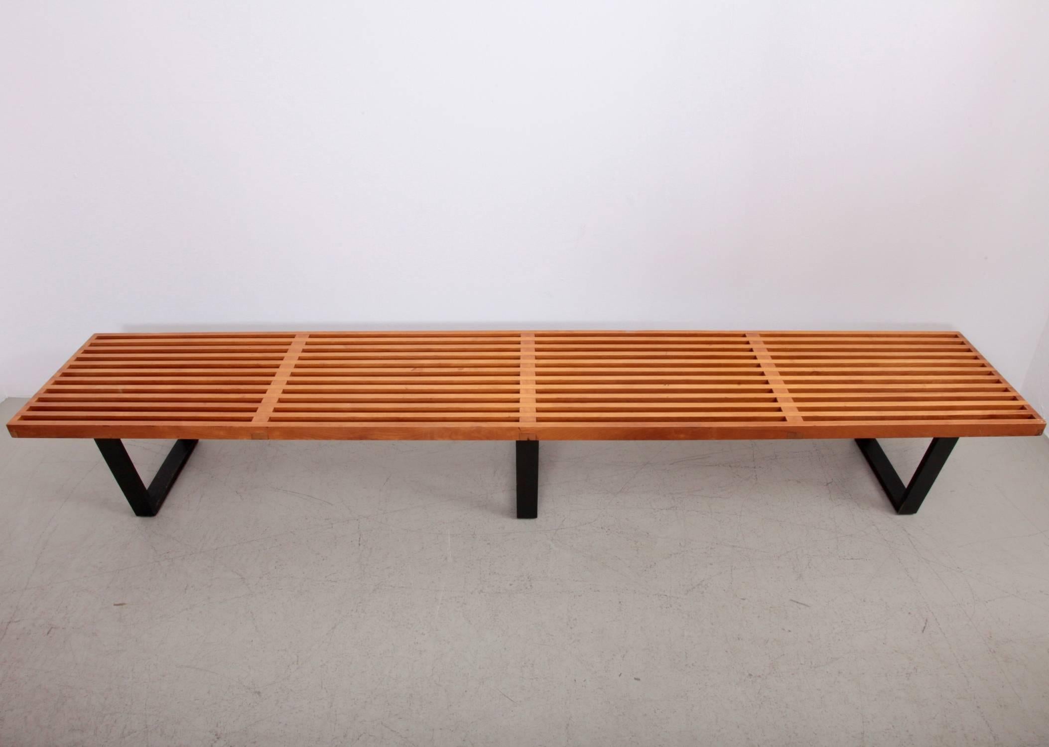 Fully original iconic George Nelson design for Herman Miller in the largest version that was available. This slat bench is constructed from natural solid maple and black lacquered wood base. This bench can be used both as seating and as a coffee or