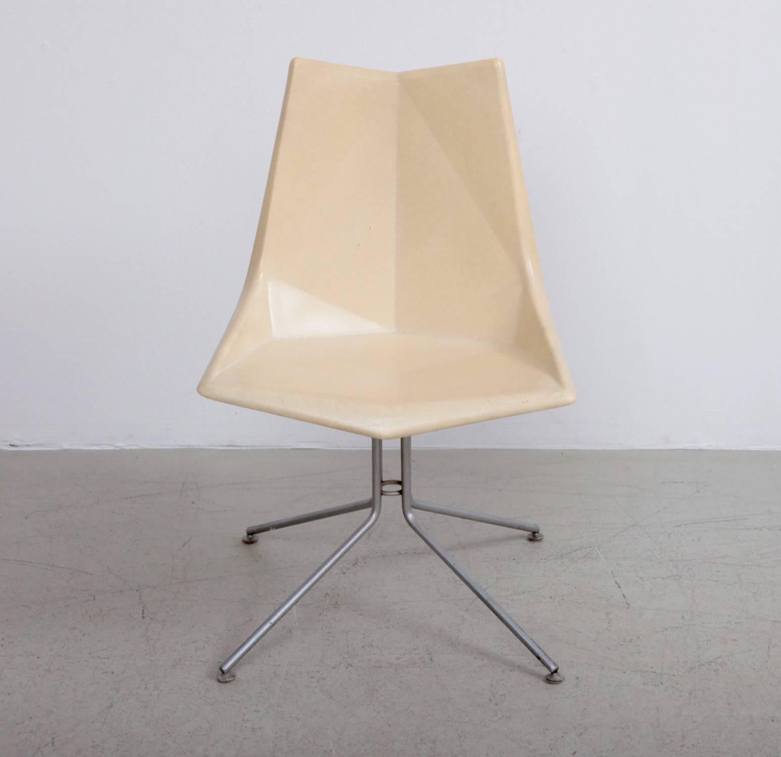 Extremely rare versions of the Paul McCobb Origami chair for St. John Seating. The fiberglass seat is molded at angles, reminiscent of the Japanese origami technique. The chair stands on tubular iron legs.

