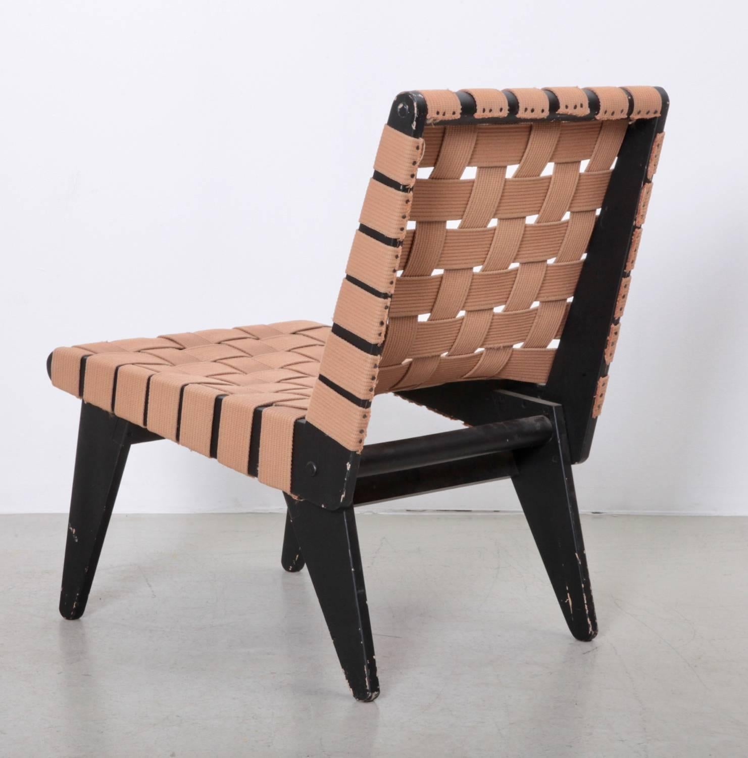 Rare large lounge chair by Klaus Grabe with beige textile straps on a black lacquered plywood frame. Chair has an authentic vintage patina.