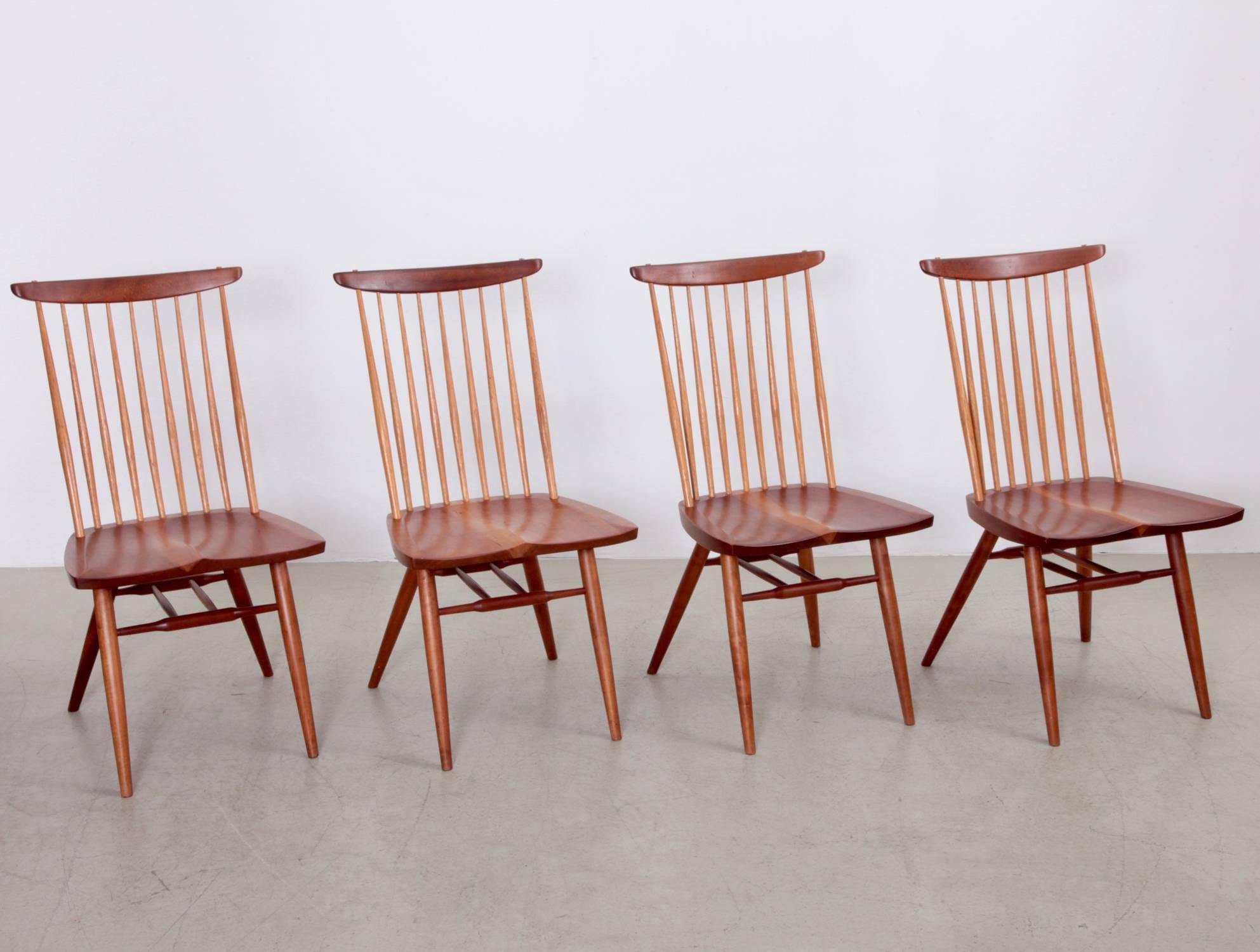George Nakashima, set of four "New" chairs in cherry, hickory spindled back and saddle seat.
