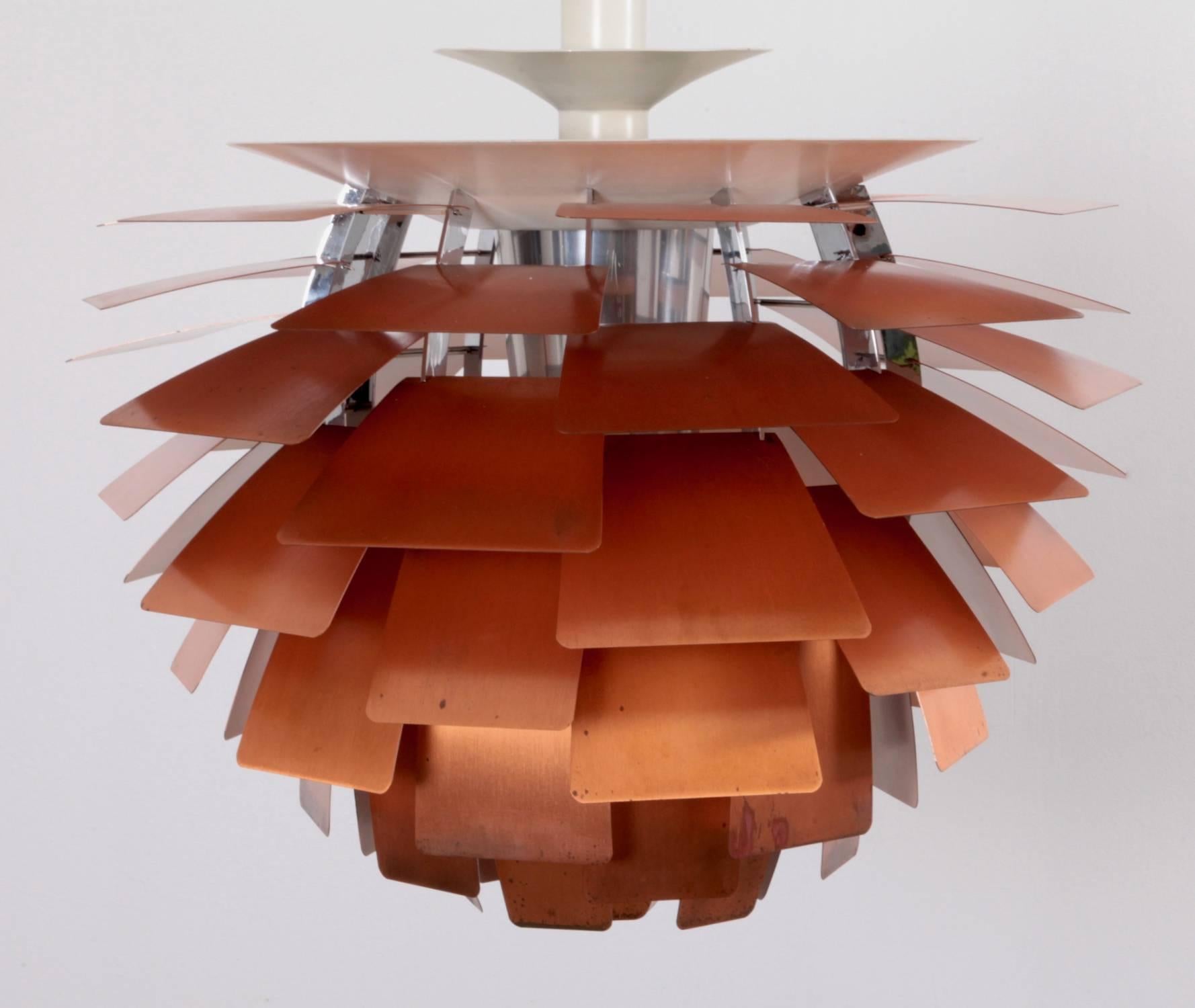 Iconic early brushed copper hanging pendant lamp by Poul Henningsen, manufactured by Louis Poulsen, Denmark. Outstanding authentic copper patina on the leaves. PH Artichoke (1958) is a 360-degree glare free Luminaire with copper leaves. One x E40