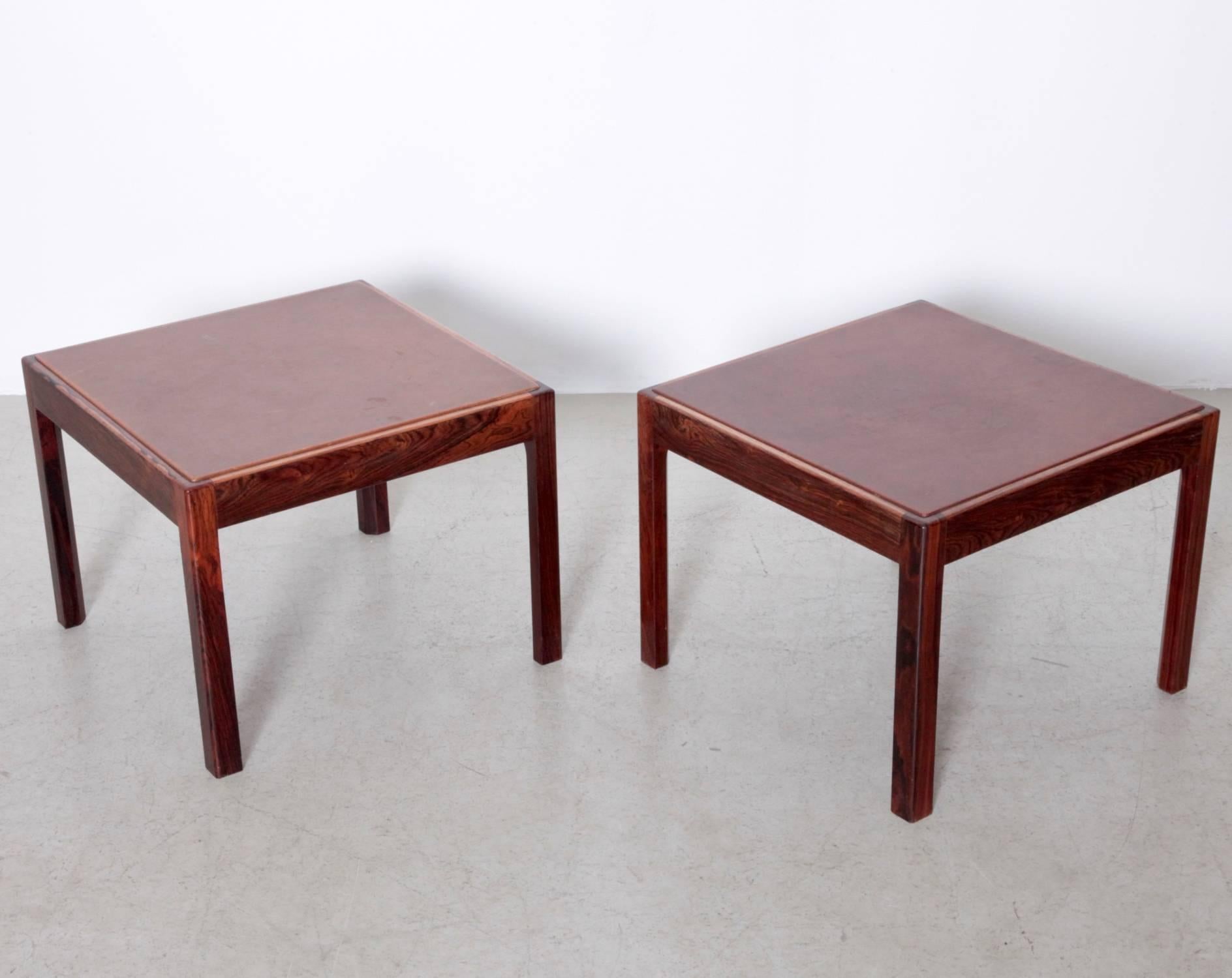 Nice 1960s pair of rosewood side table with original leather top in a beautiful vintage patina on the leather.