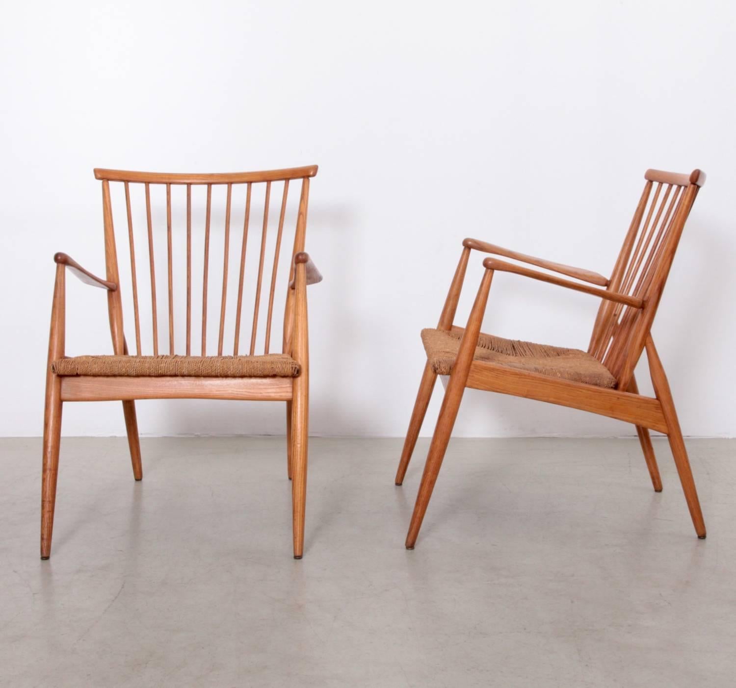 Excellent pair of German studio lounge chairs with papercord seats and solid ash frame.

