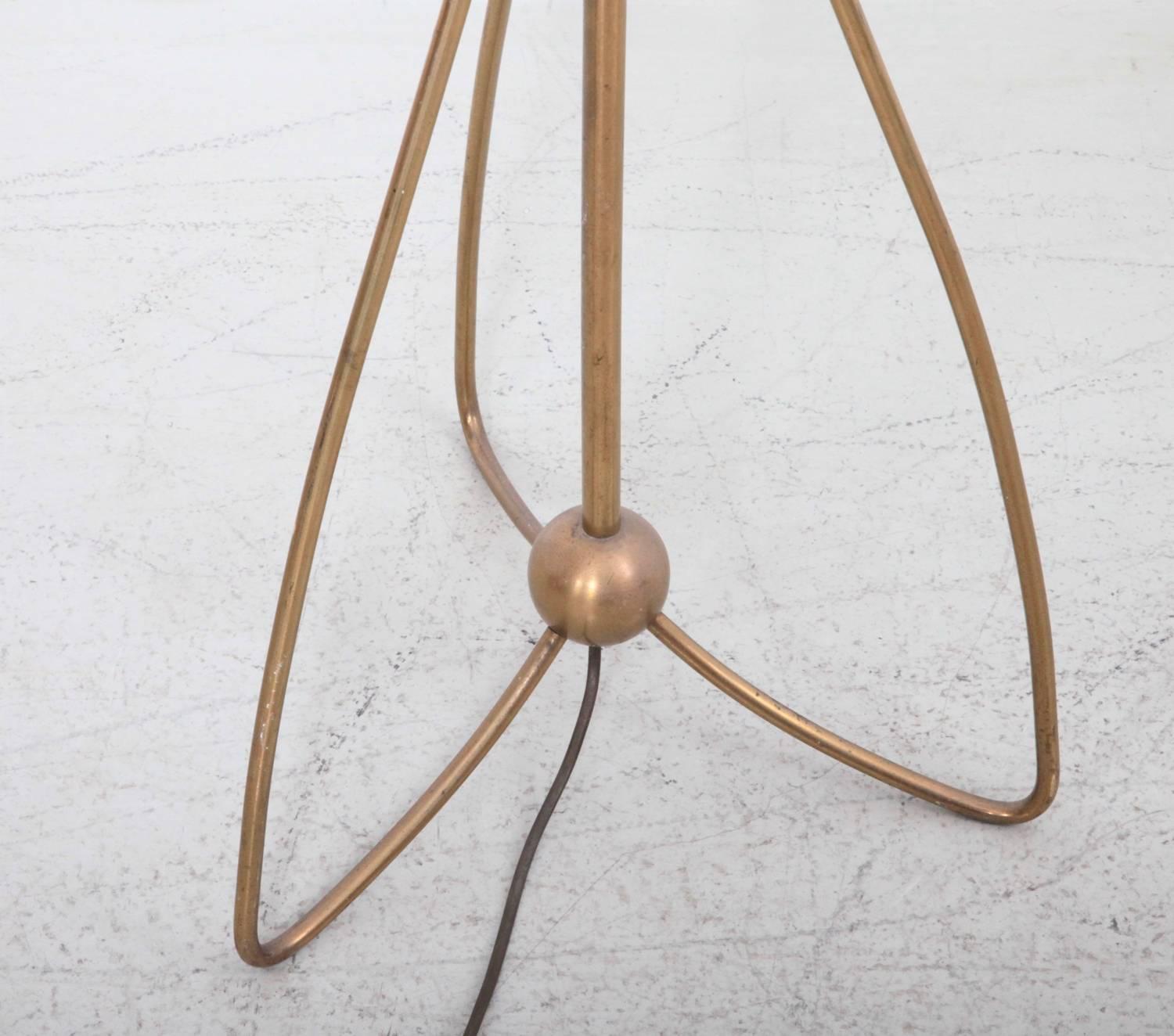 Very elegant high quality 1950s floor lamp with a tripod pinleg foot. All brass with new shade.