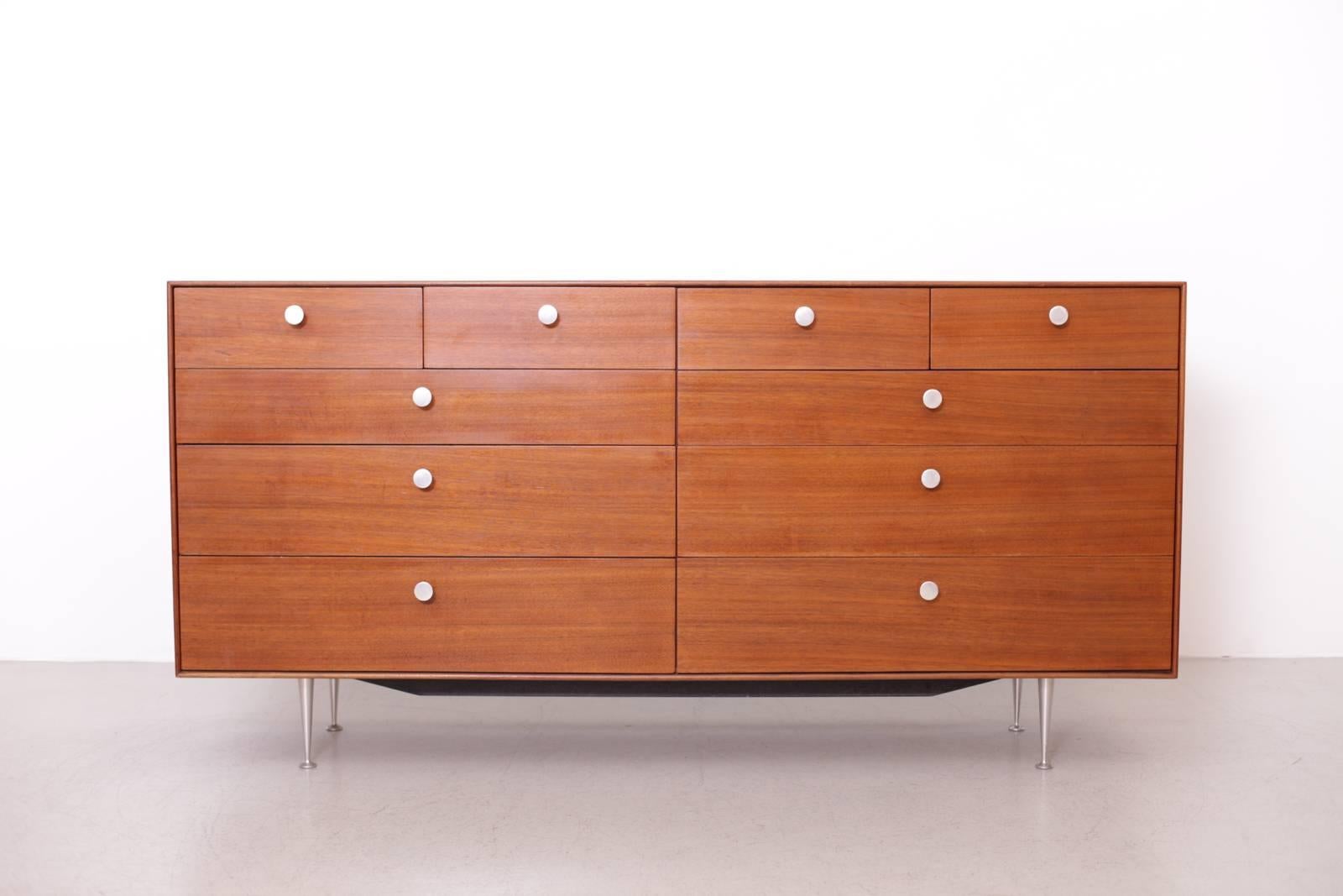 Rare thin edge chest of drawers in very good condition. Aluminum pulls and legs. The drawers are very smooth and easy going. A beautiful Mid-Century Classic.