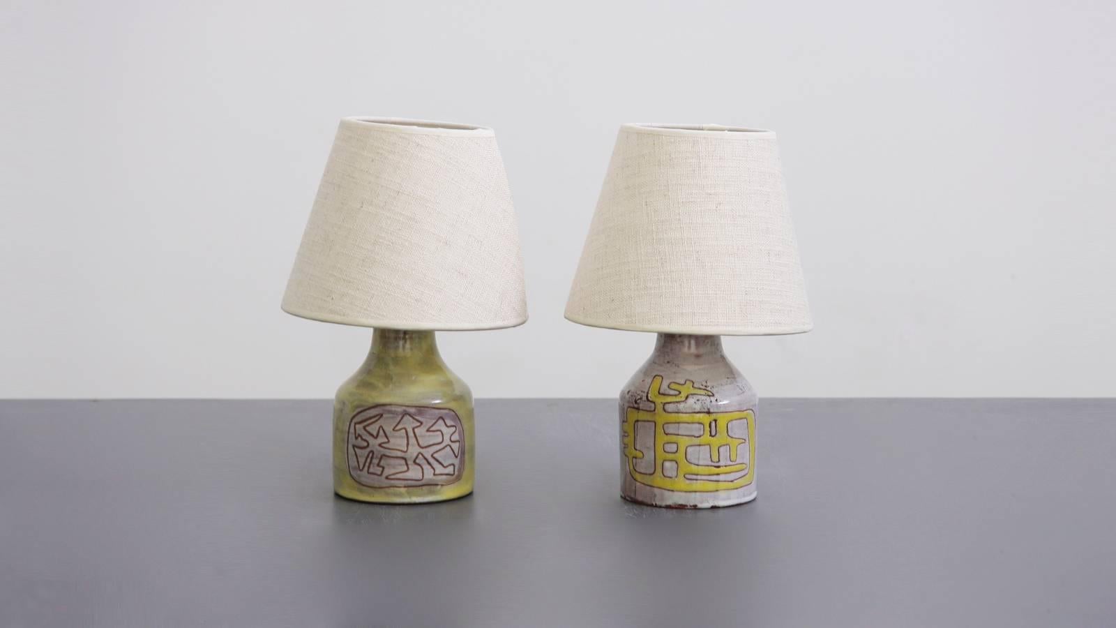 Very cute pair of small ceramic table lamps by Juliene Derel Rivier with some small chips.