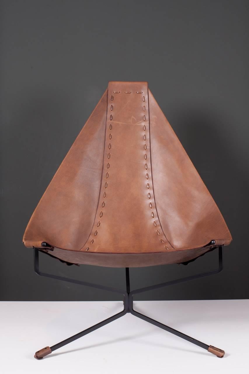 Lounge chair made of Latigo leather on a black steel base. The lotus chair was designed in 1969 while Daniel was living in Topanga Canyon, California. In 1970, he moved his design activities to Soquel, California, where he built a workshop in an old