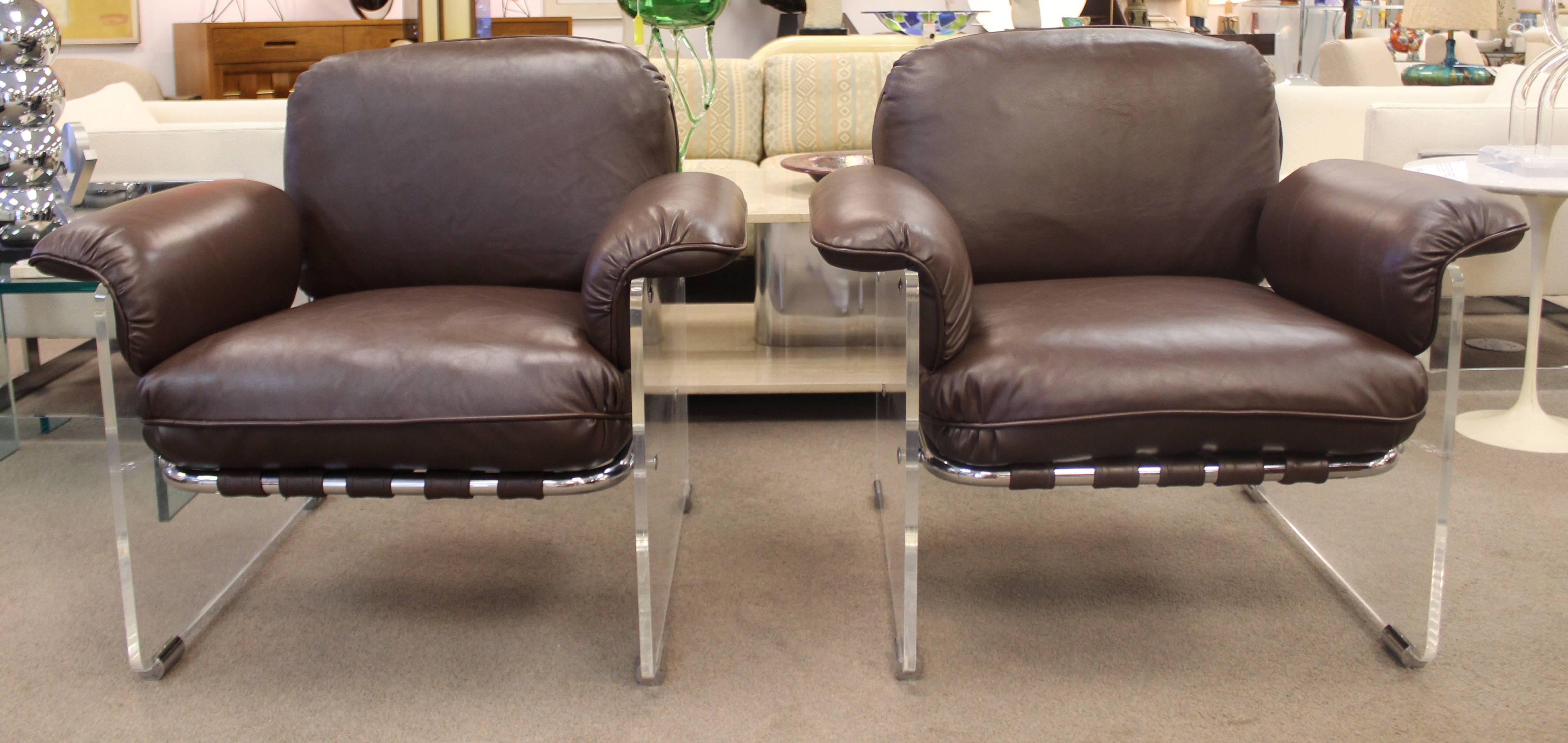 For your consideration is a rare and unique pair of pace argente chrome, thick Lucite and brown leather lounge chairs. In great condition, just had them reupholstered in chocolate brown Italian leather. The dimensions are 35