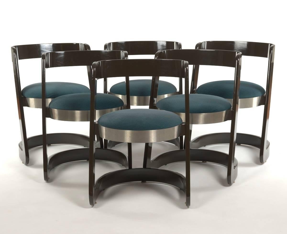 Willy Rizzo for Mario Sabot dining set. The dining table is rectangular with a dark brown formica top banded in aluminum. Mounted on a massive rectangular formica plinth standard terminating in an extended steel platform base. Measures: 63