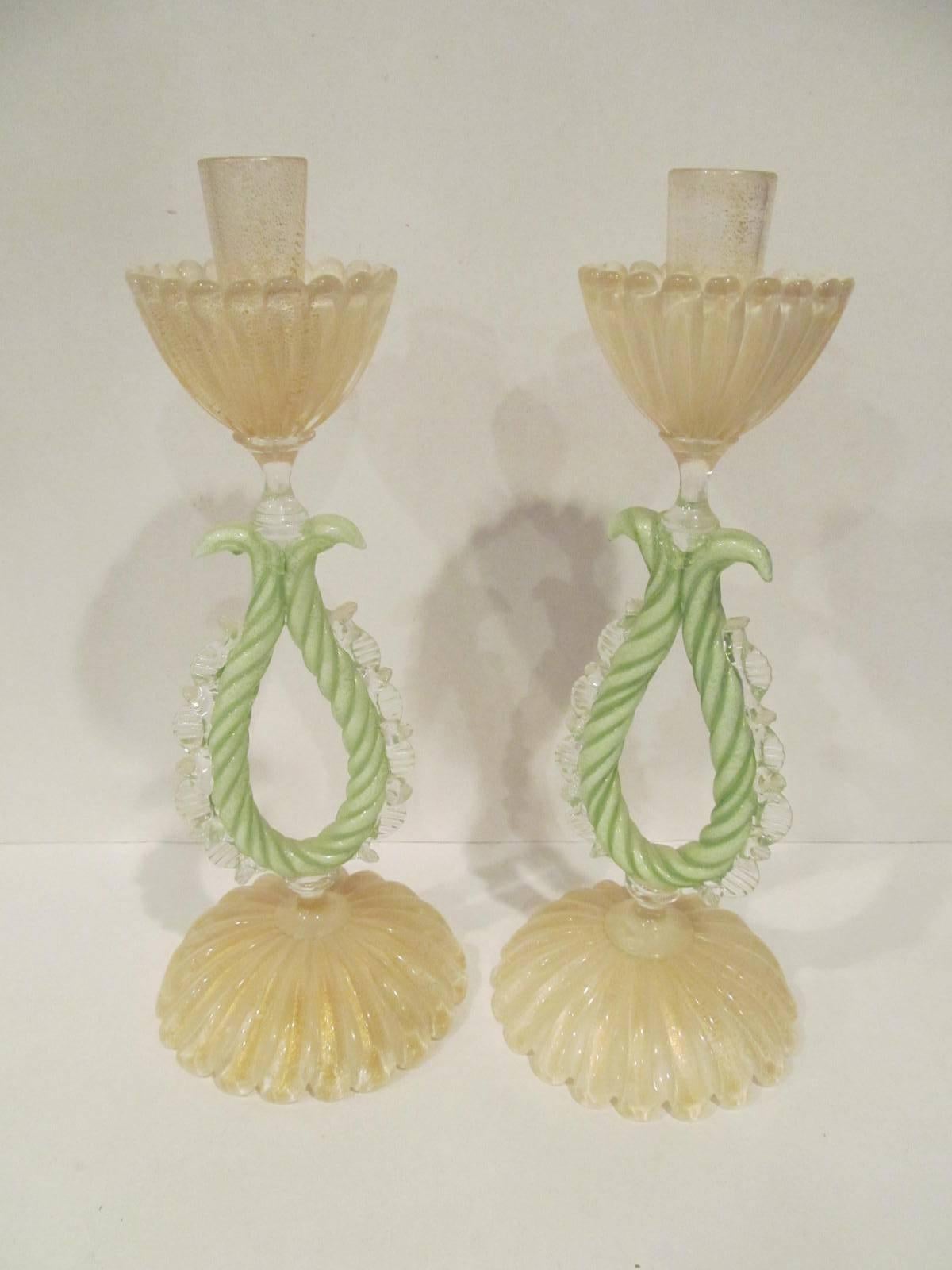 Great pair of Murano candlesticks, circa 1950s. White with gold highlights, clear with gold highlights, with center portion green, with gold highlights.