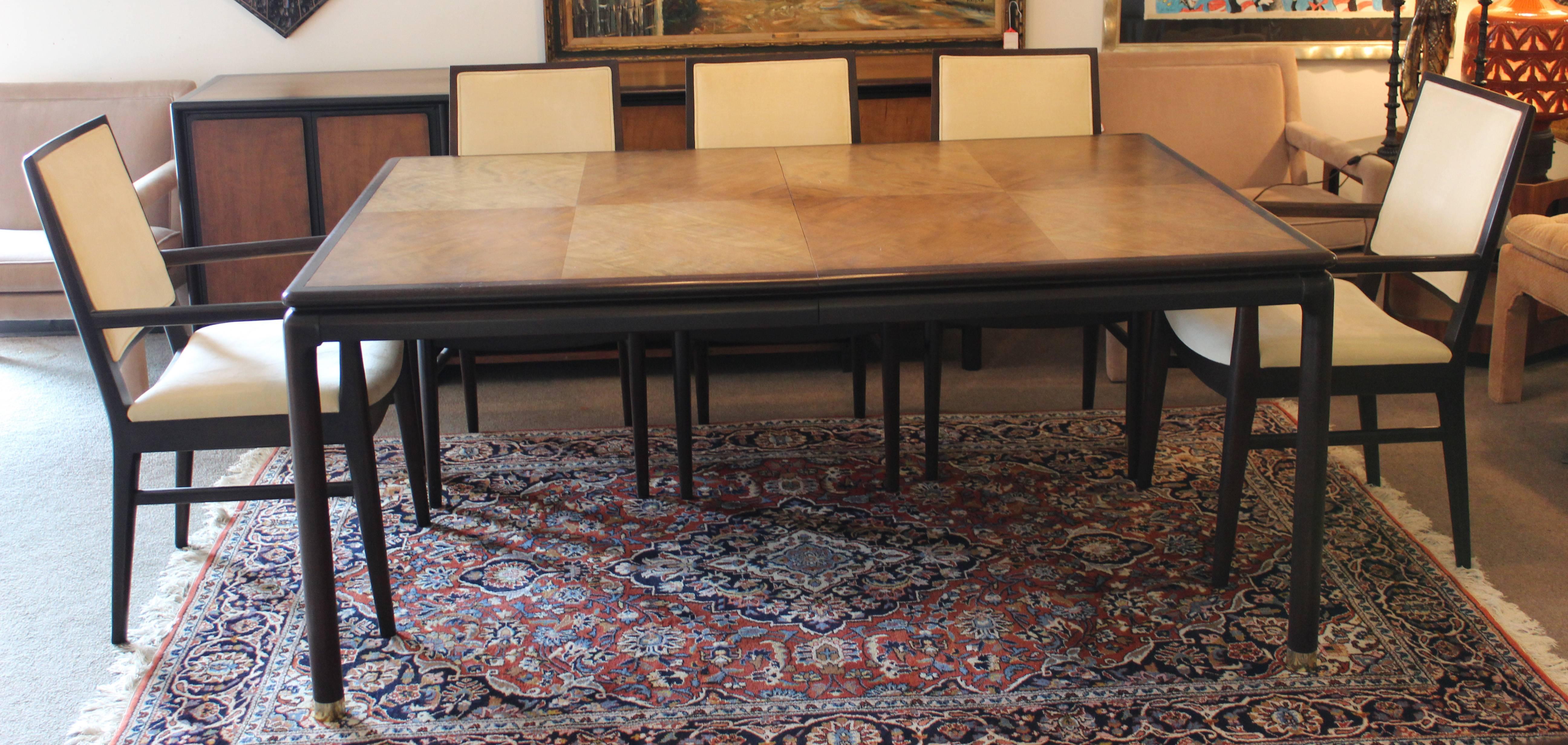 Incredible, walnut dining table with two leaves and eight matching chairs. Both table and chairs have beautiful curves. Walnut and ebonized walnut. Six side chairs and two armchairs. In excellent condition. The dimensions of the table are 45