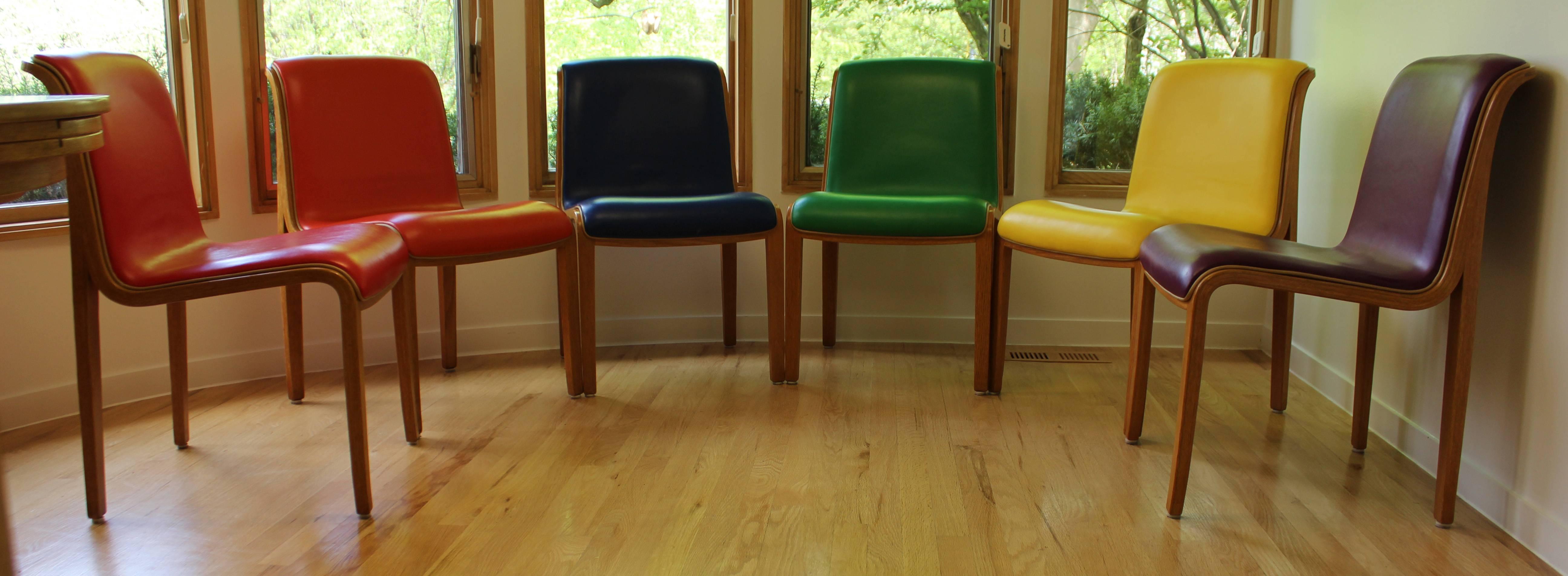 For your consideration is a funky set of six dining chairs, each seat's leather is a different color of the rainbow. In excellent condition. The dimensions are 19.5
