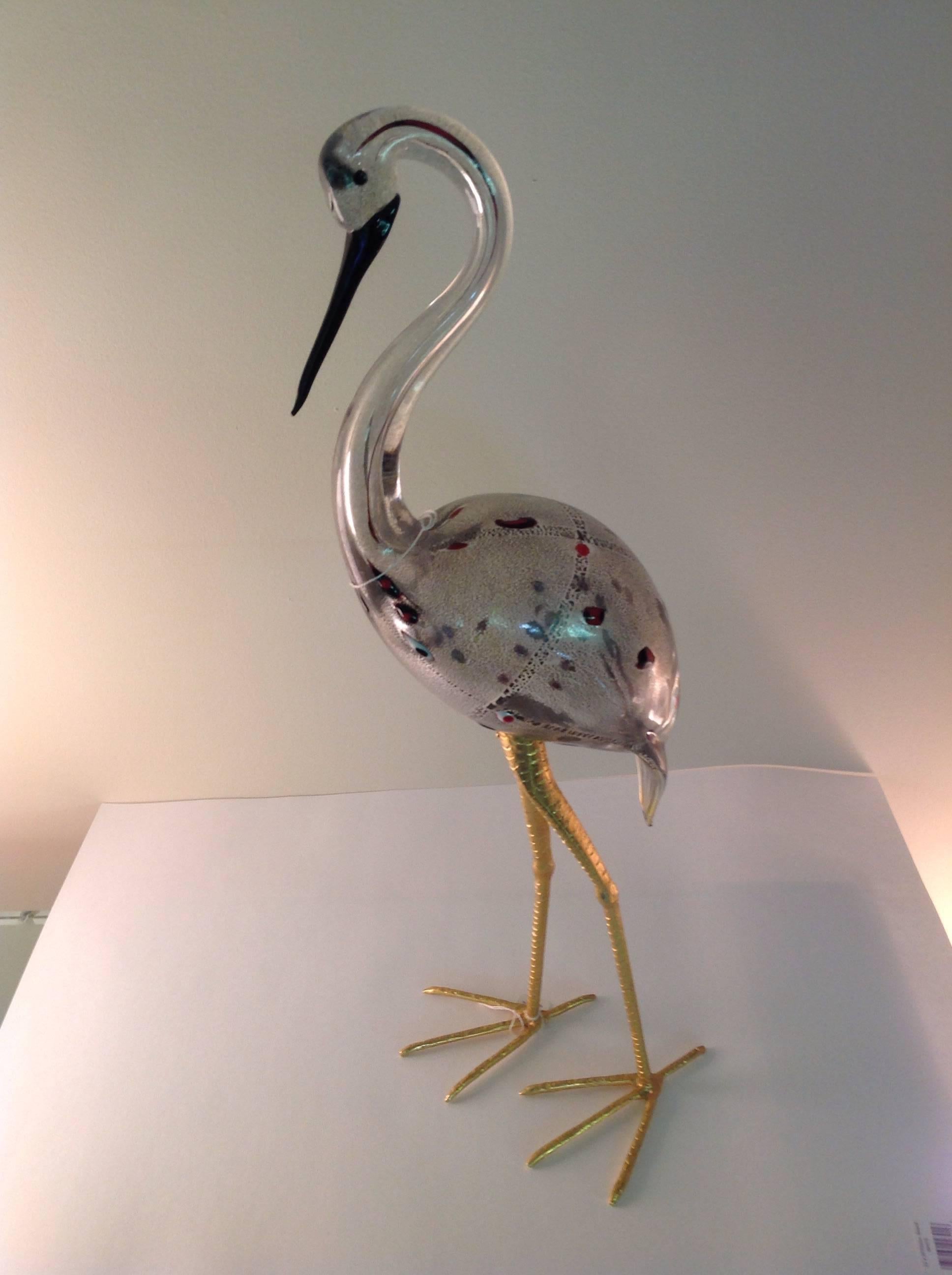 Great pair of Murano birds by Licio Zanetti. Each bird is signed. Larger bird is 28.75 inches tall, by 10 inches wide, by 8.75 inches deep. Smaller bird is 25 inches tall, by 8.5 inches wide by 8.25 inches deep. Both on removable brass legs.