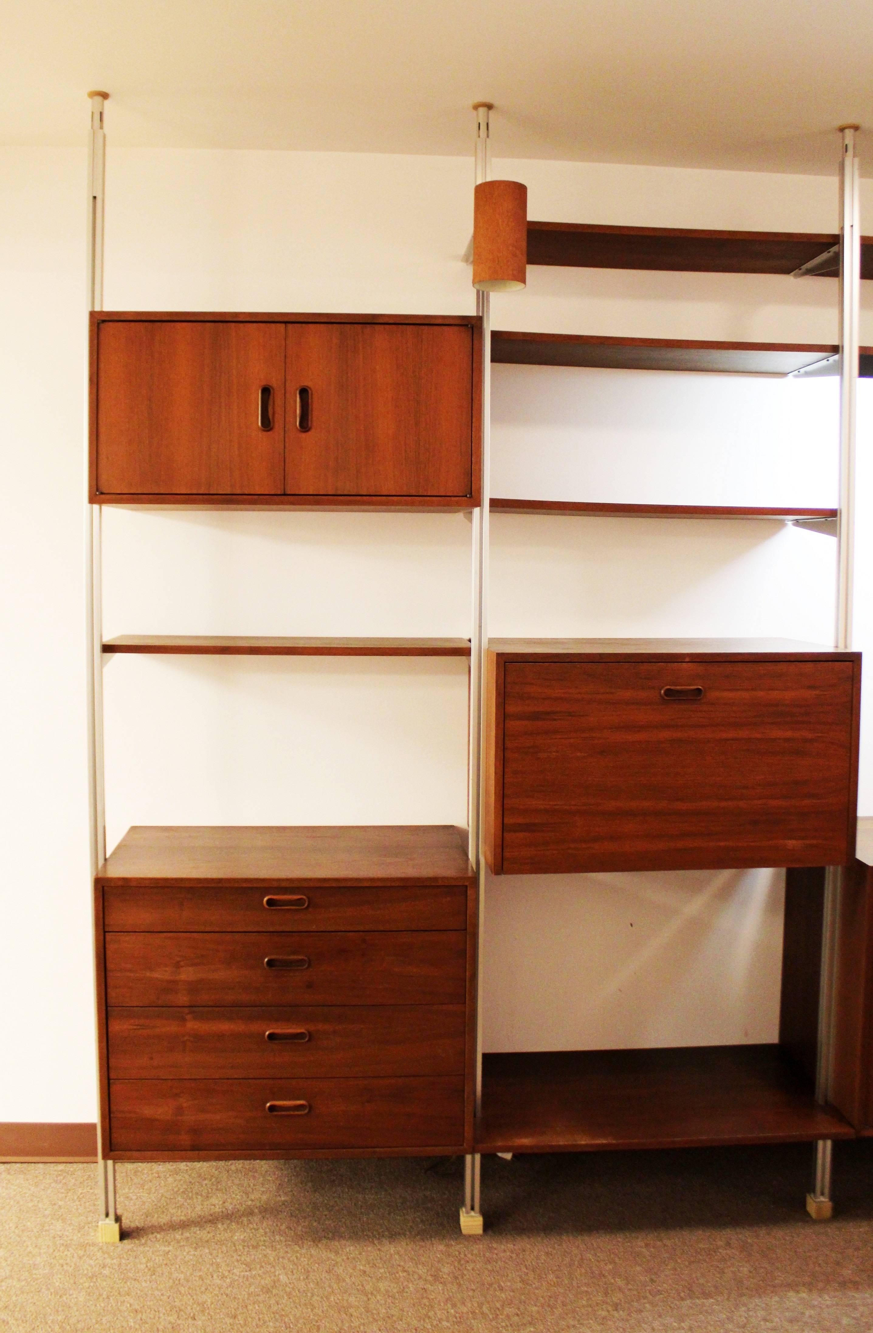 Massive and magnificent Omni four bay walnut wall unit. Multiple shelves, drawers and lights designed by George Nelson for Herman Miller.