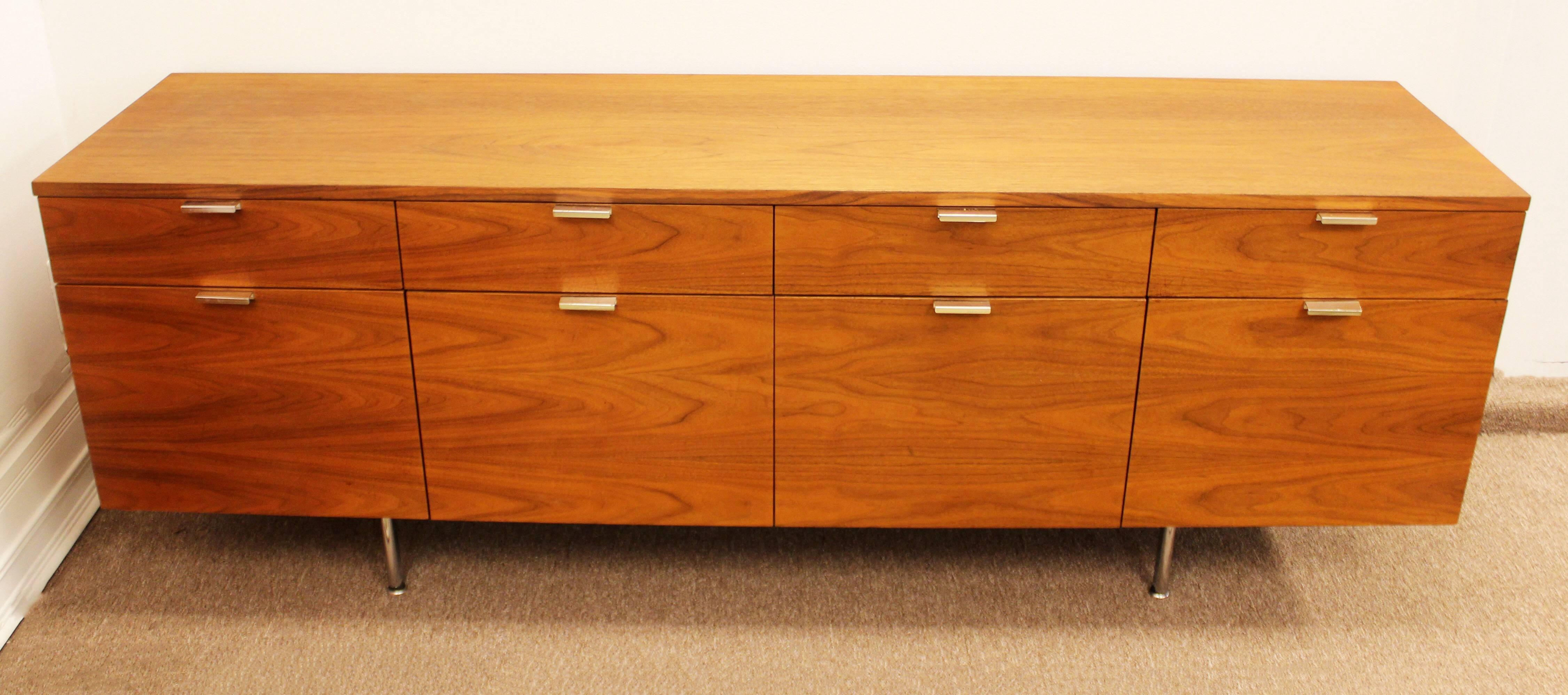 Signed beautiful eight-drawer credenza in walnut by George Nelson for Herman Miller. Chrome legs and chrome pulls with four shallow and four deep drawers.