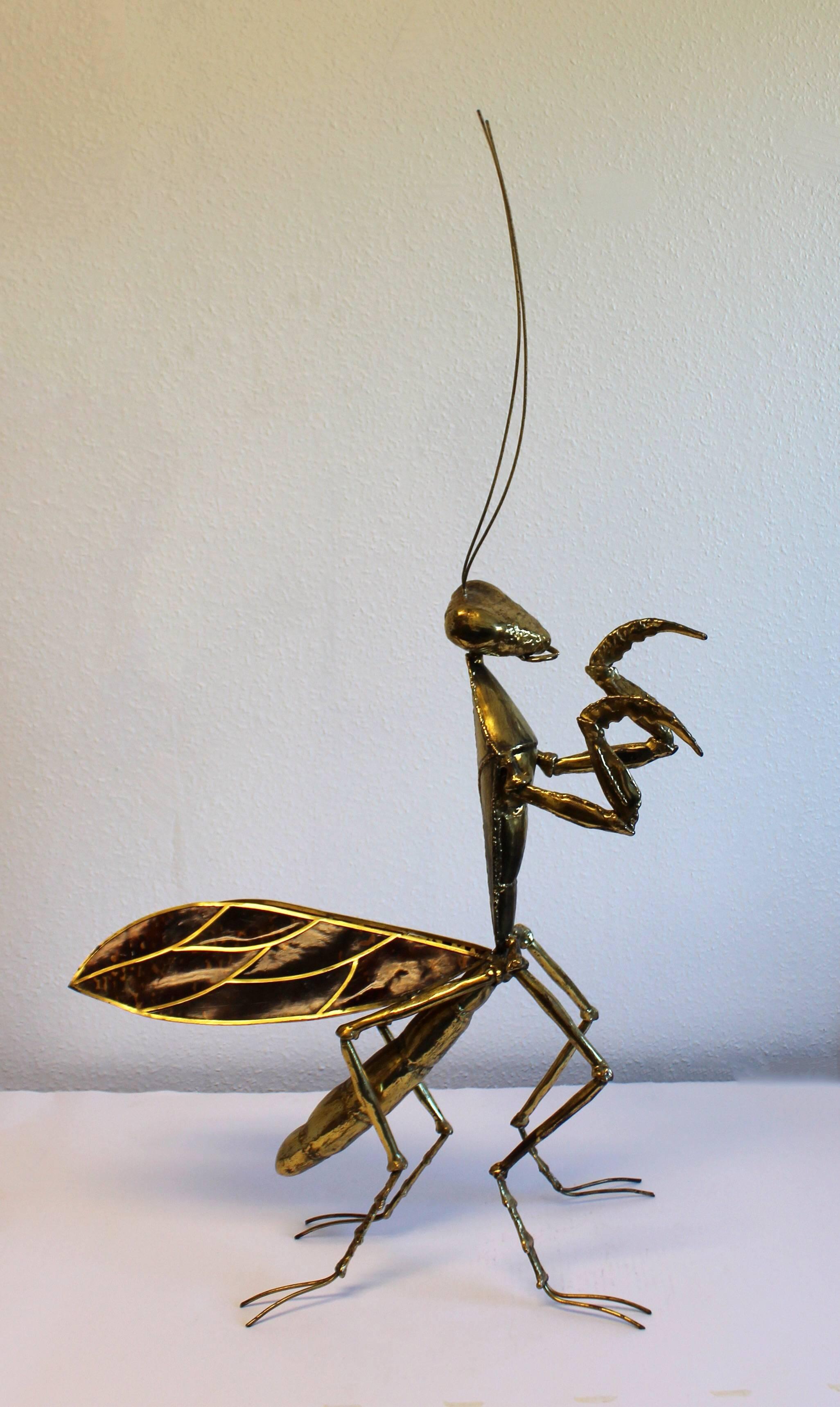 Amazing work of art by Jacques Duval Brasseur. The large sculpture is of a brass praying mantis with celluloid wings. Comes with original paperwork. In great condition. The dimensions are 8" W x 25" D x 45" H.
   