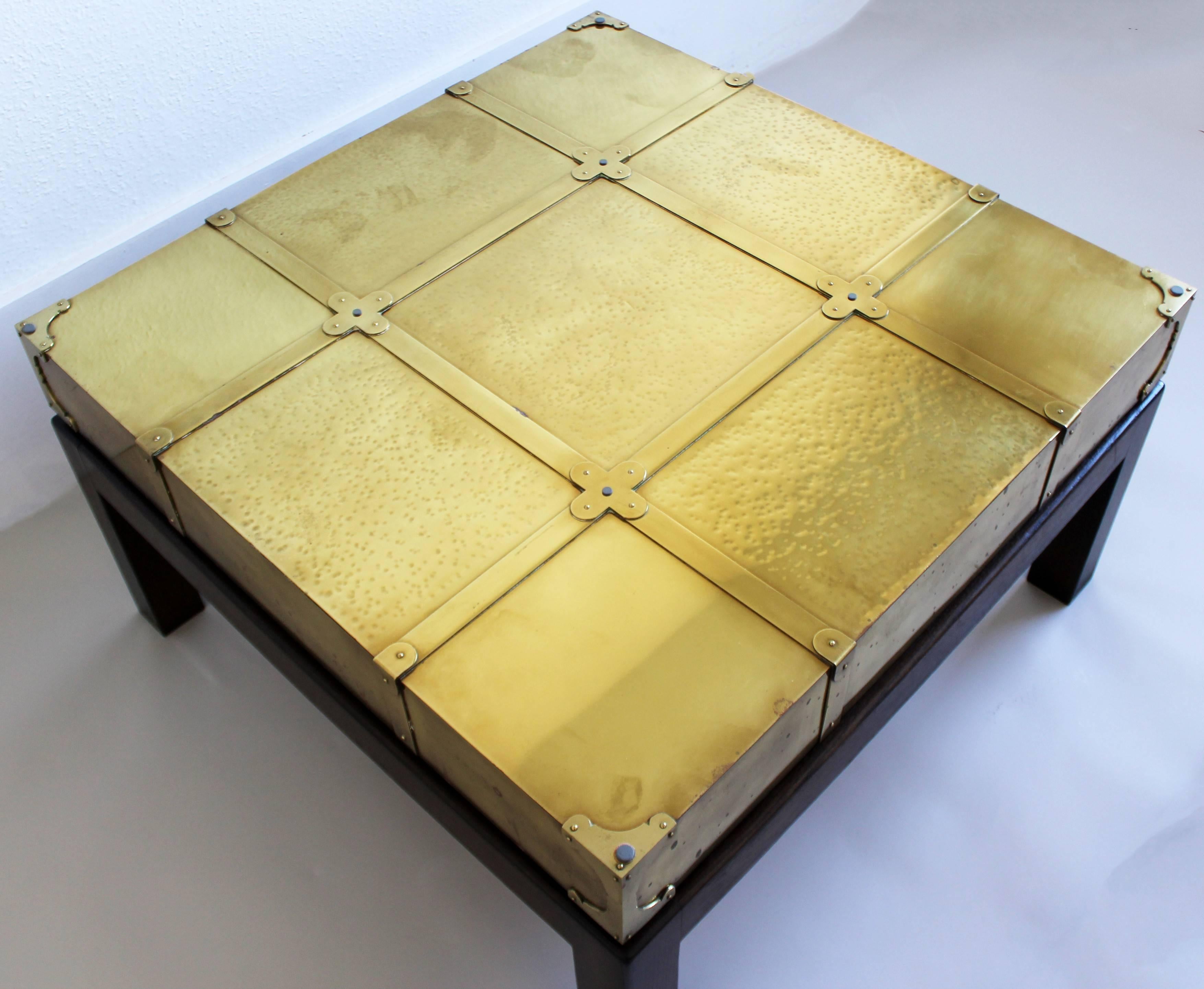 For your consideration is a beautiful, brass coffee table, on a wooden base and with a glass top, by Sarreid Ltd. of Spain, with original tags. In good vintage condition. The dimensions are 30.5" W Sq x 17.5" H.