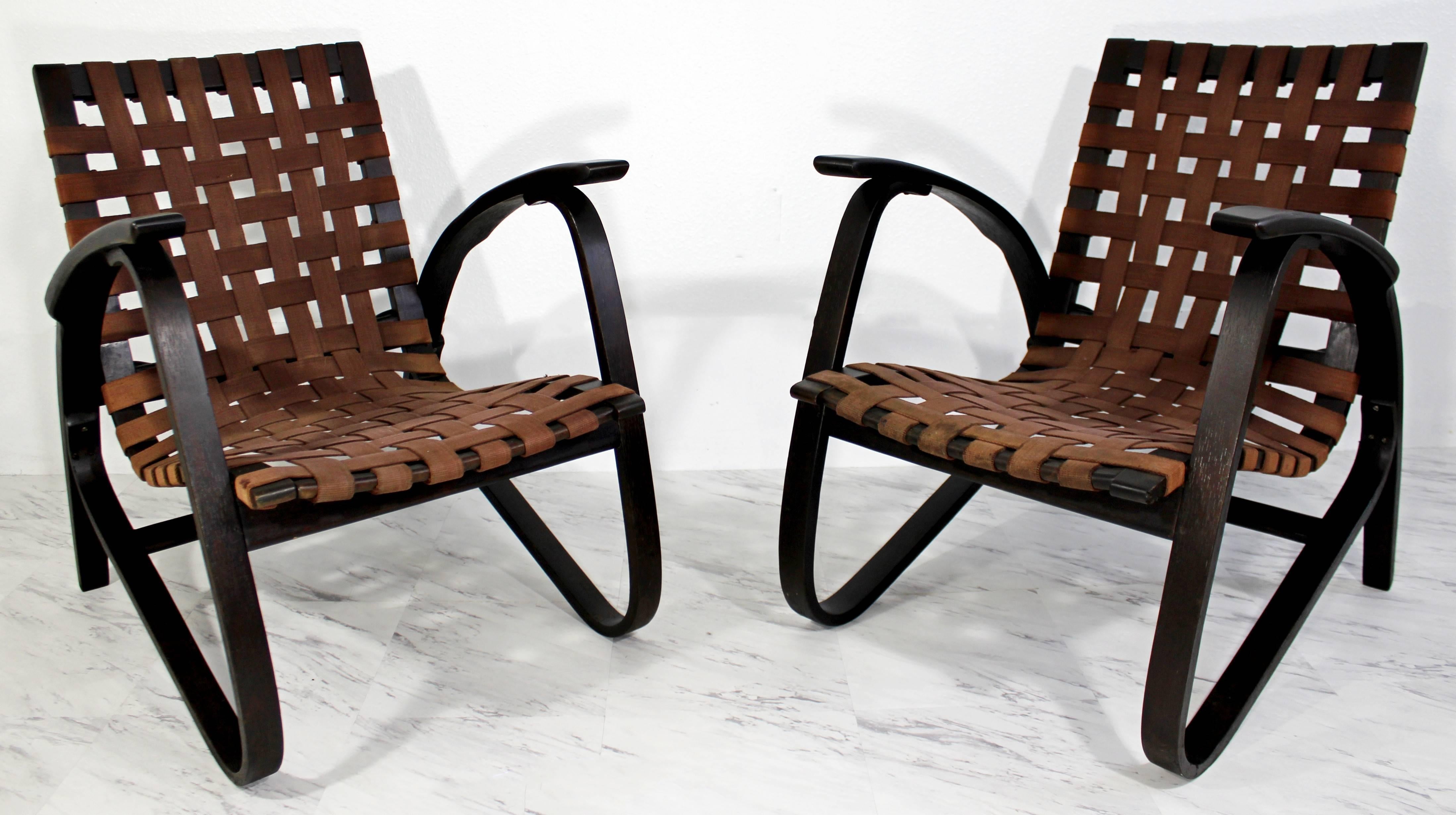 Absolutely gorgeous pair of black bentwood armchairs, with brown woven original strap seats, by Jan Vanek, circa 1930s. In great condition. The dimensions are 24