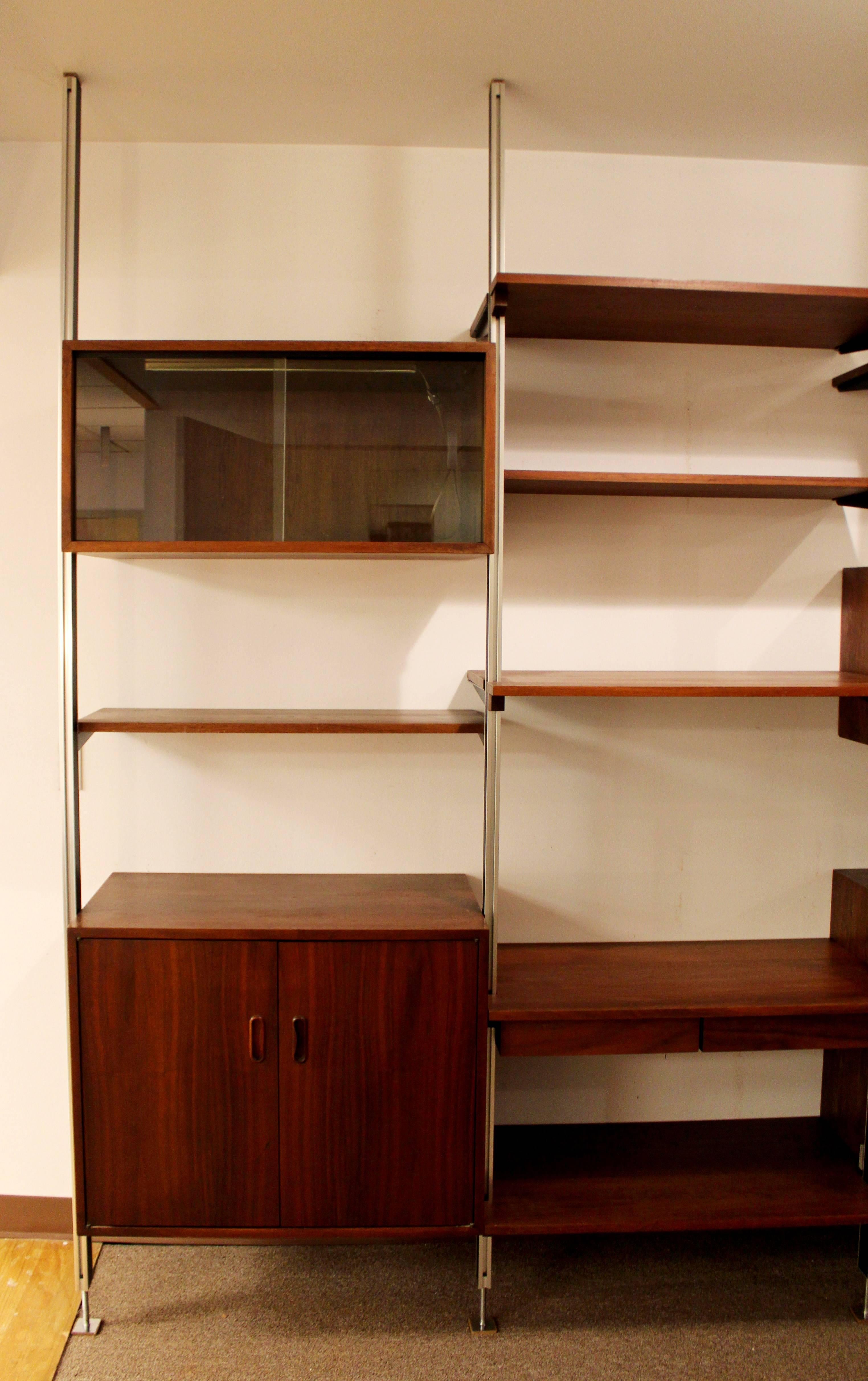 Omni wall shelf unit or room divider. Made of walnut and aluminum, by George Nelson. With tambour doors, sliding glass front, light up section. In excellent condition. The dimensions are 130