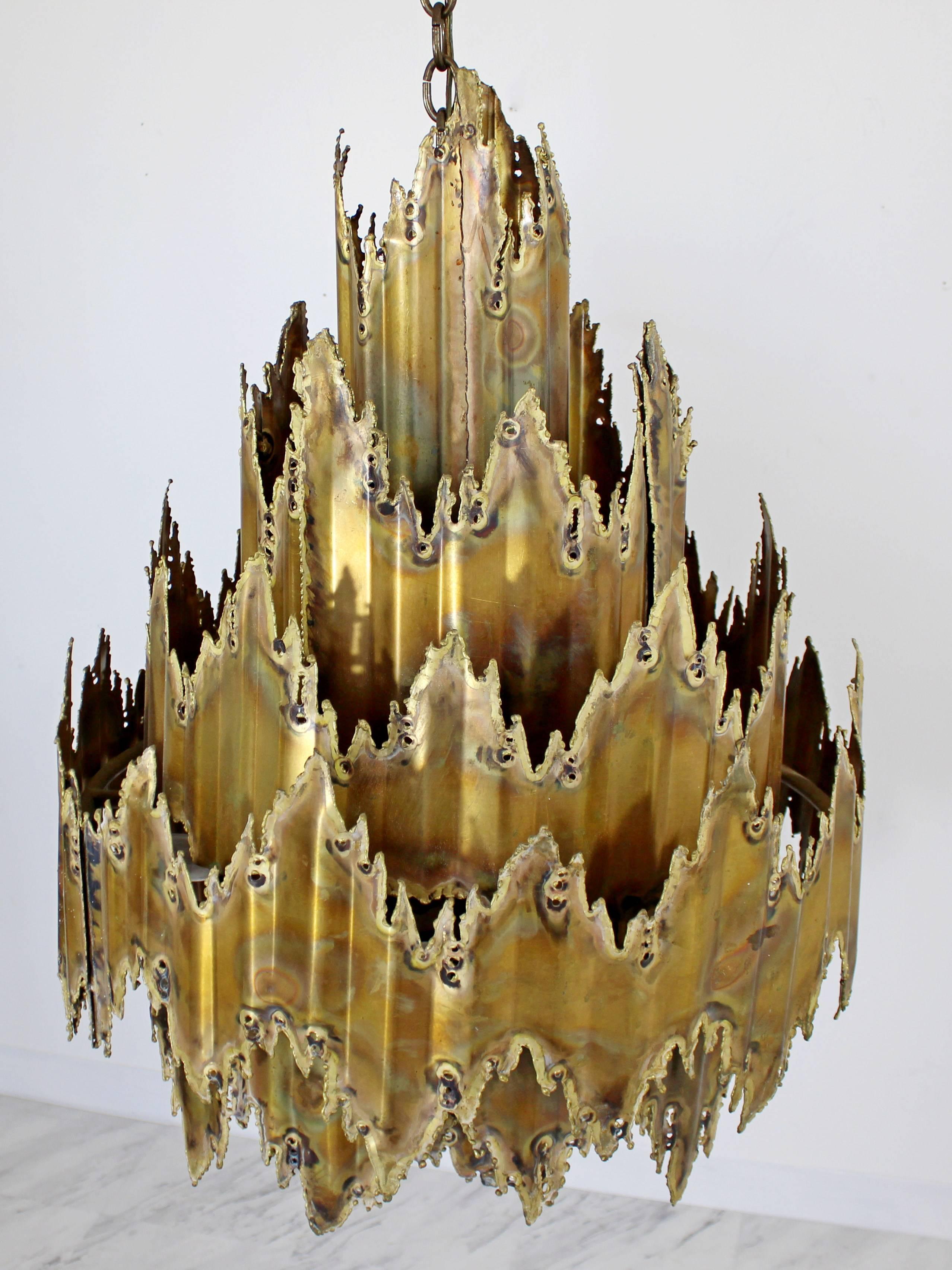 For your consideration is this beautiful brass torch cut brutalist Tom Greene chandelier measuring in at 31