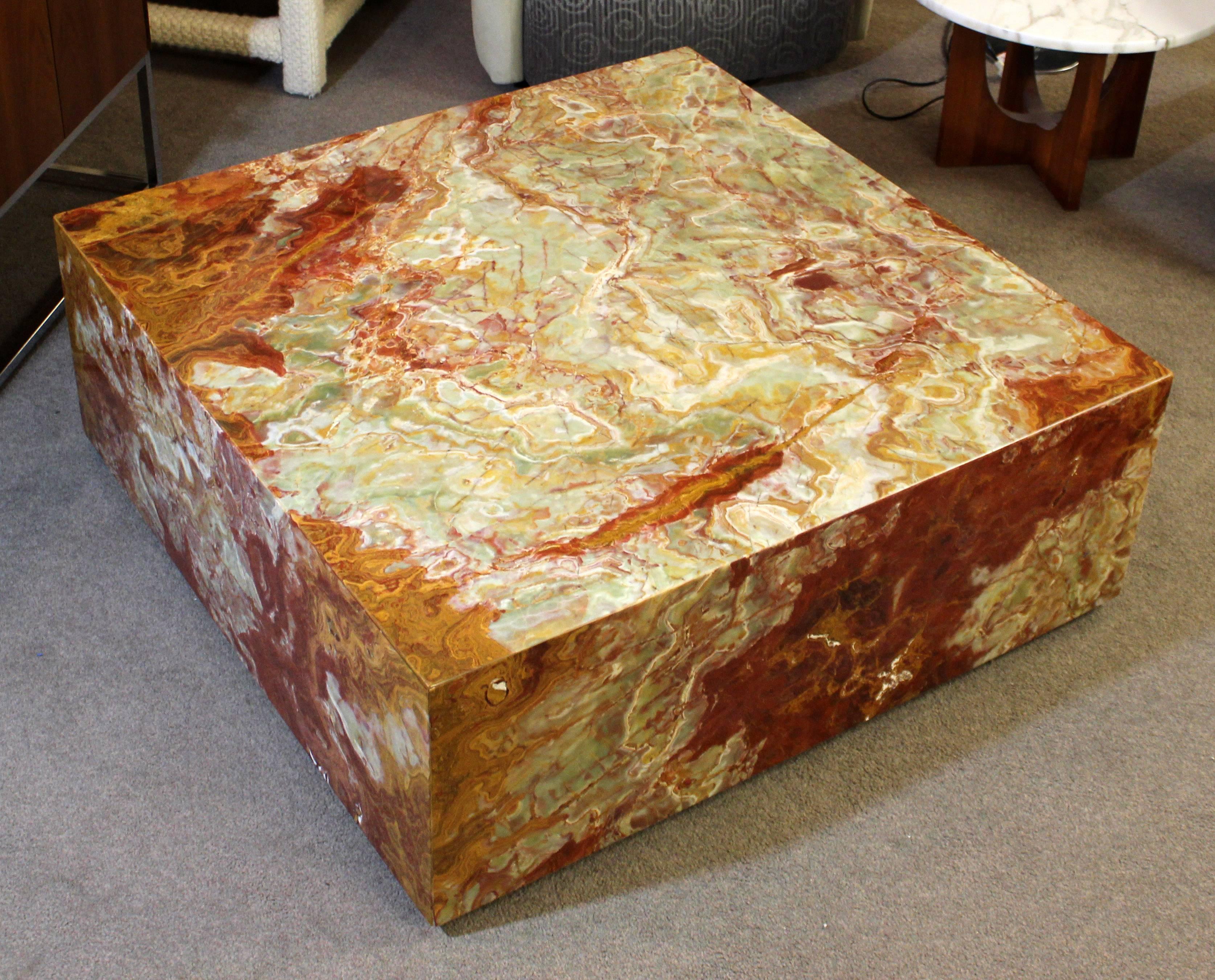 
For your consideration is a remarkably exquisite, square, marble/onyx coffee table, on wheels. The marble/onyx table is exceptional and the color scheme is breathtaking!! In excellent condition. The dimensions are 42" Sq x 16" H.