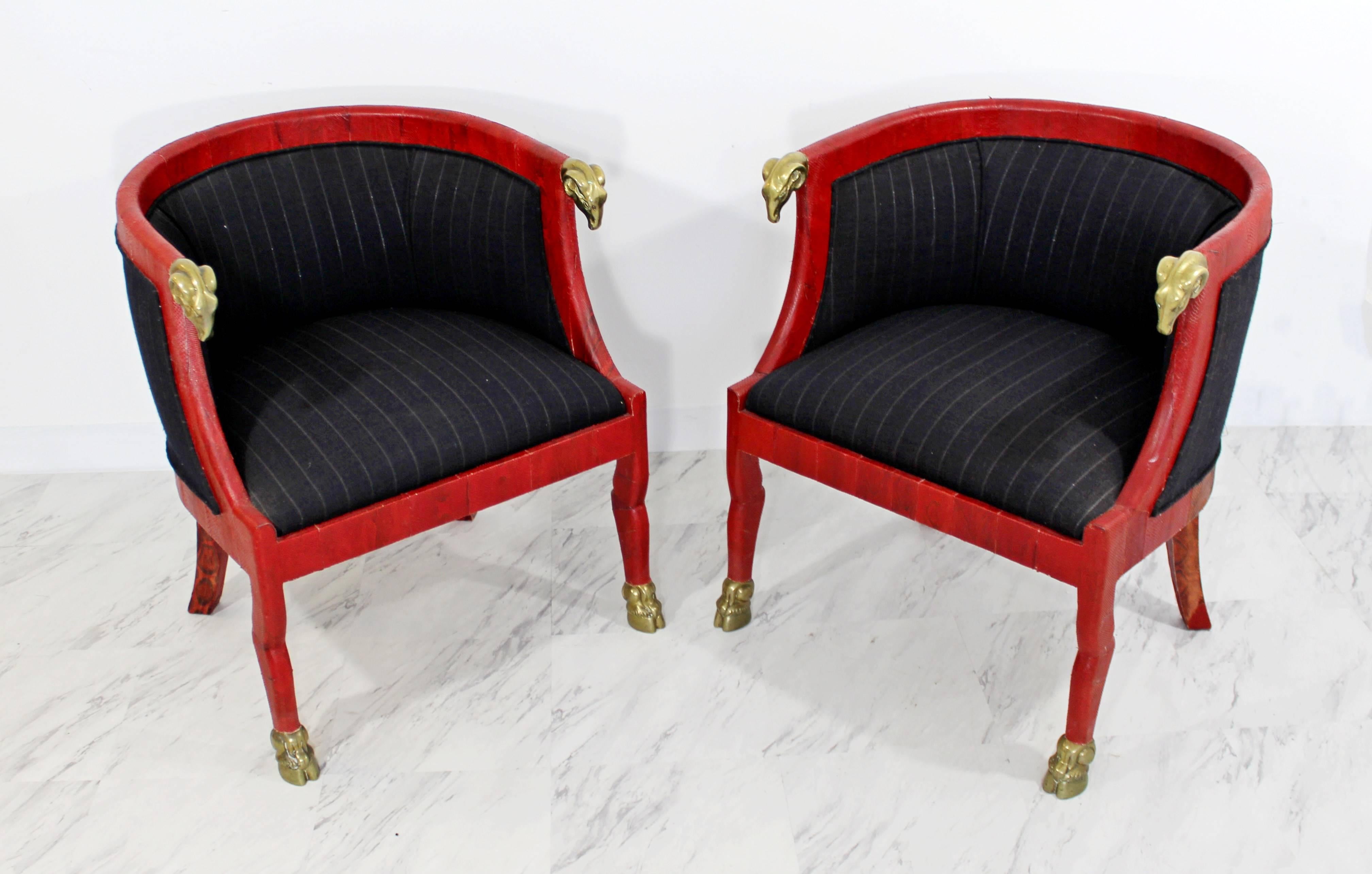 For your consideration is a sculptural pair of Hollywood Regency Barrel, club chairs, handmade in Columbia, with red goatskin and bronze rams heads and feet In excellent condition. Tag reads Pordominsky decorating. The dimensions are 24