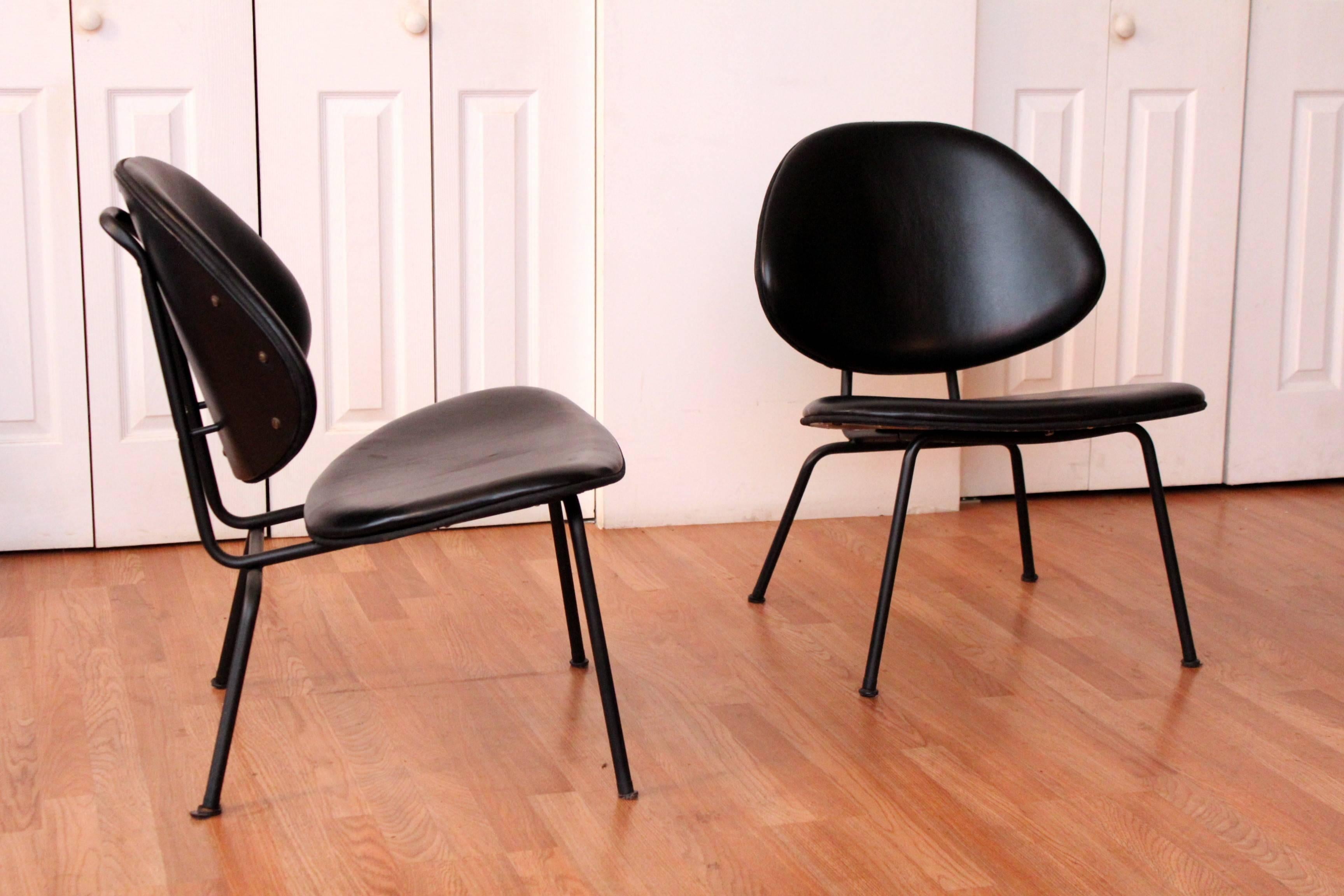 A pair of Mid-Century tubular clam shell chairs by Homecrest. These chairs were recently recovered in a rich black leather and offer an amazing sit.