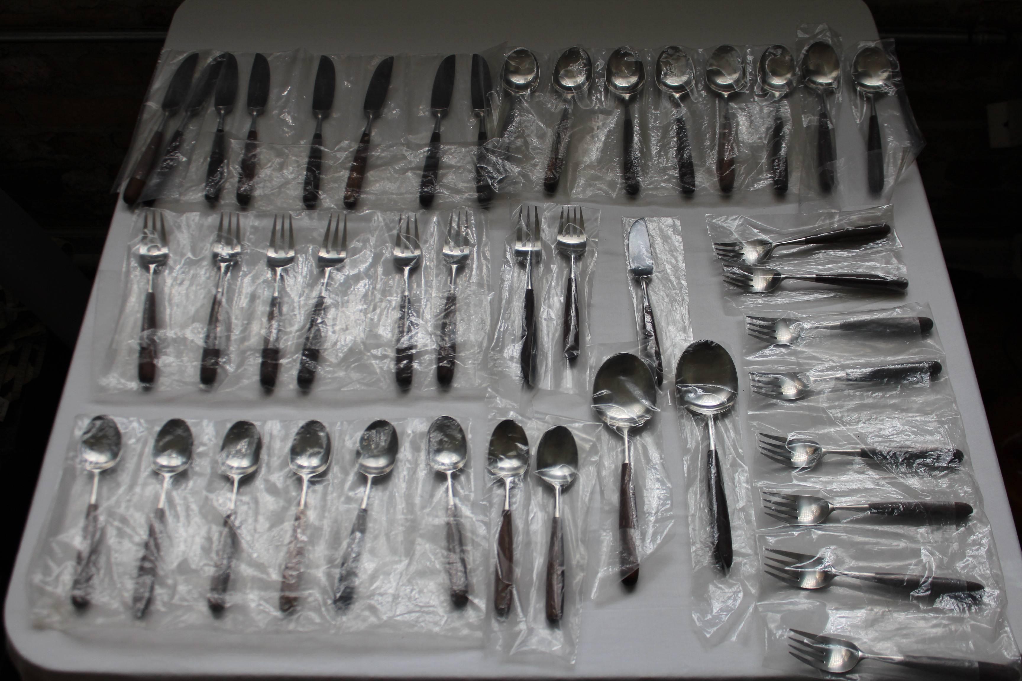 Eight five-piece place settings. 
Two serving spoons 
One butter knife. 
43 pieces in total. 
Six place setting are stamped 