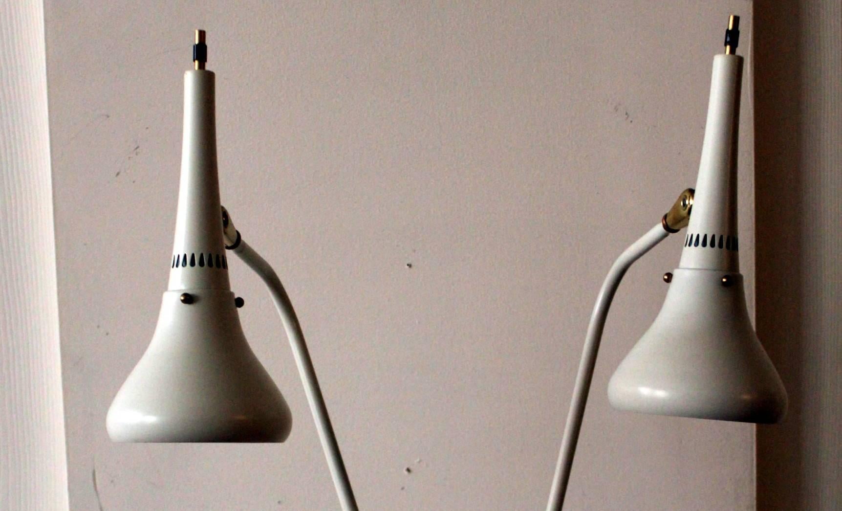 Double cone lamp in the manner of by Gerald Thurston for Lightolier. This sexy, long armed beast has twin adjustable heads, resplendent in a 