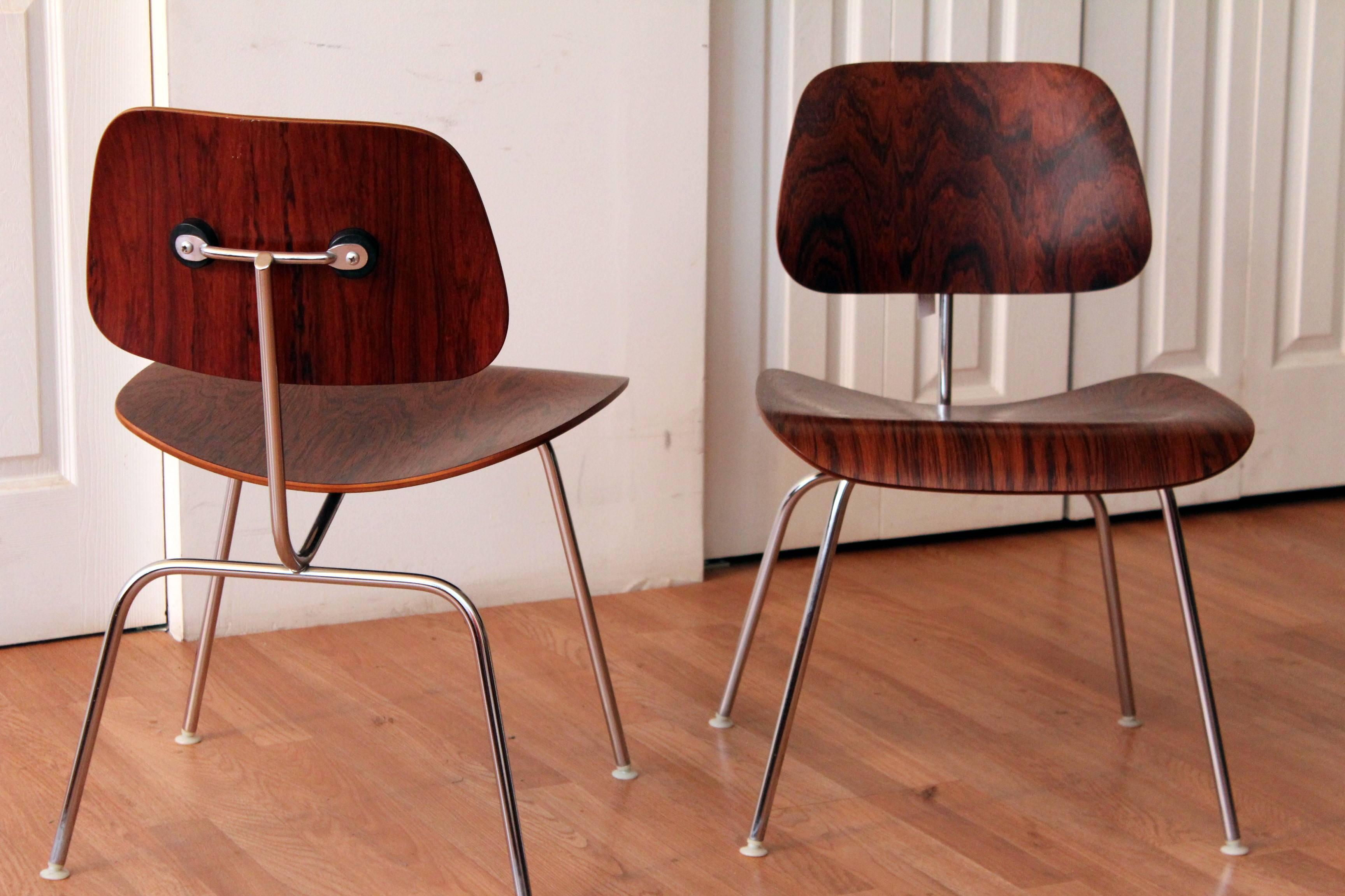 Unbelievable pair of DCM (dining chair metal) chairs by Charles and Ray Eames for Herman Miller, in the highly sought after rosewood! All original. No pitting, welds or wobbles.

Beautifully labeled.