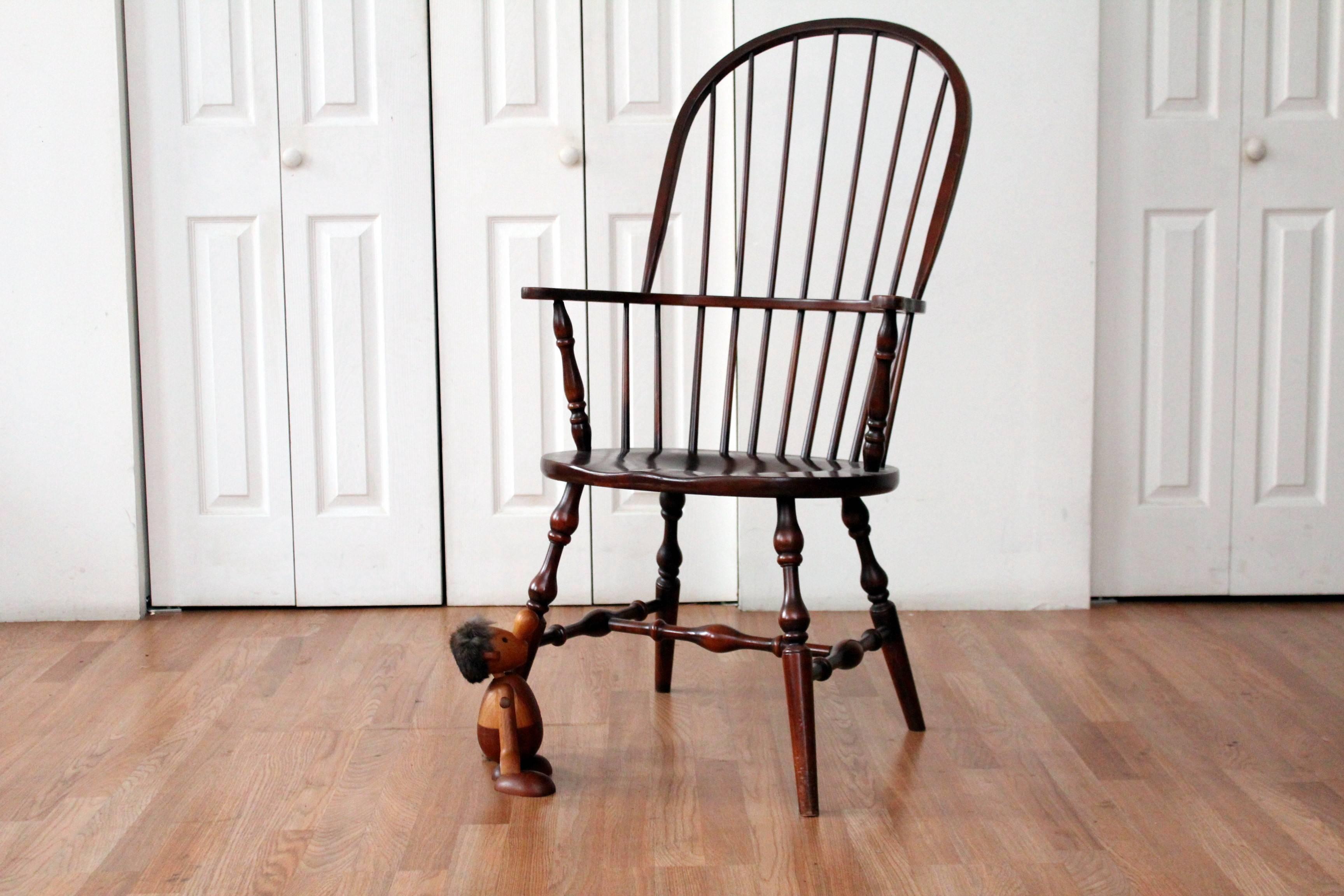 This sack-back Windsor chair by the Habersham Company, boast vase and ring turnings and a carved saddle seat that allows an unbelievable comfortable 