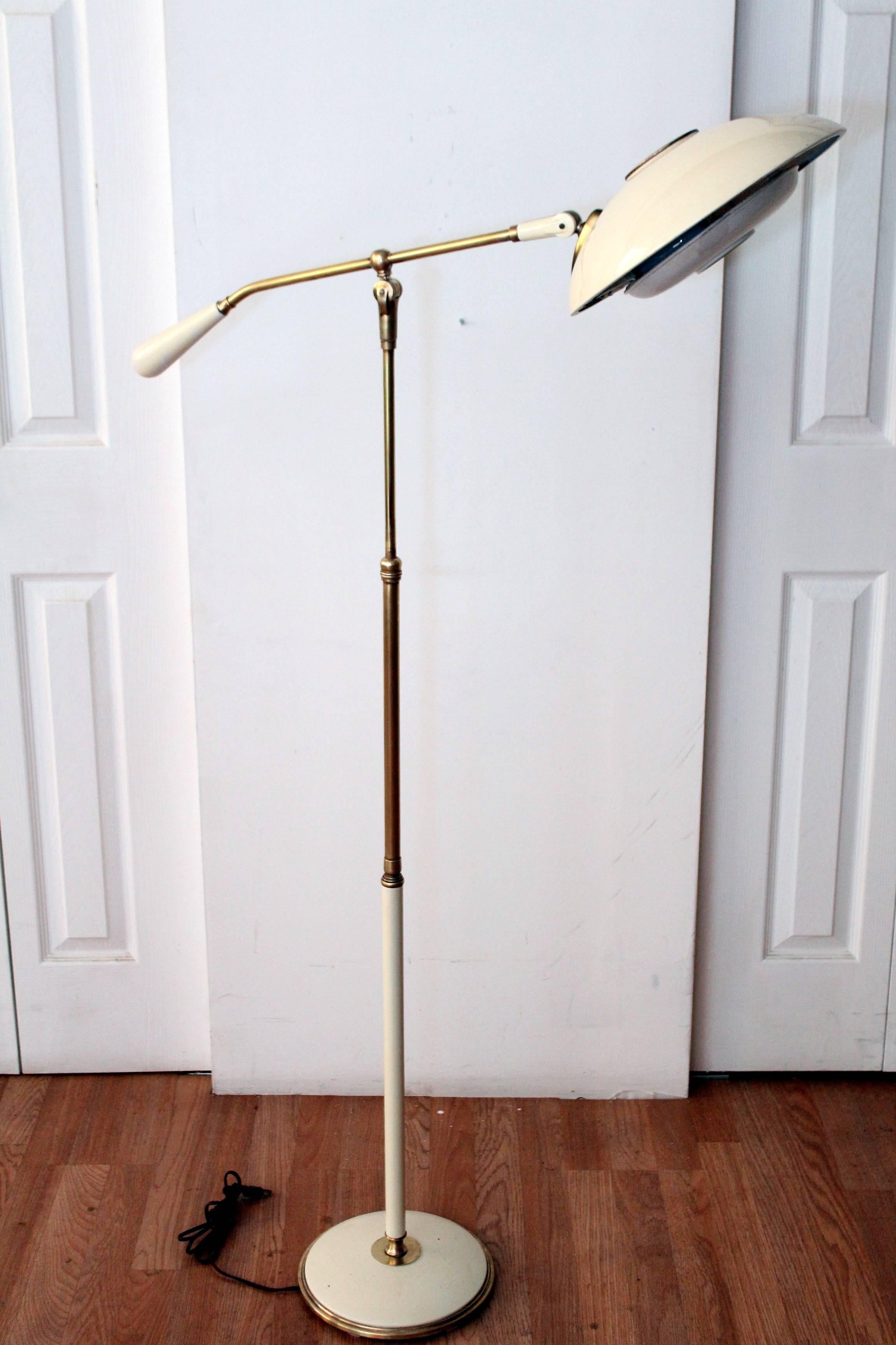 Gerald Thurston articulating saucer brass and enamel floor lamp for Lightolier. Gorgeous brass patina and creamy 