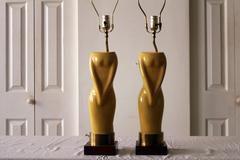 Pair of Womens Figural Yellow Lamps with White Shades