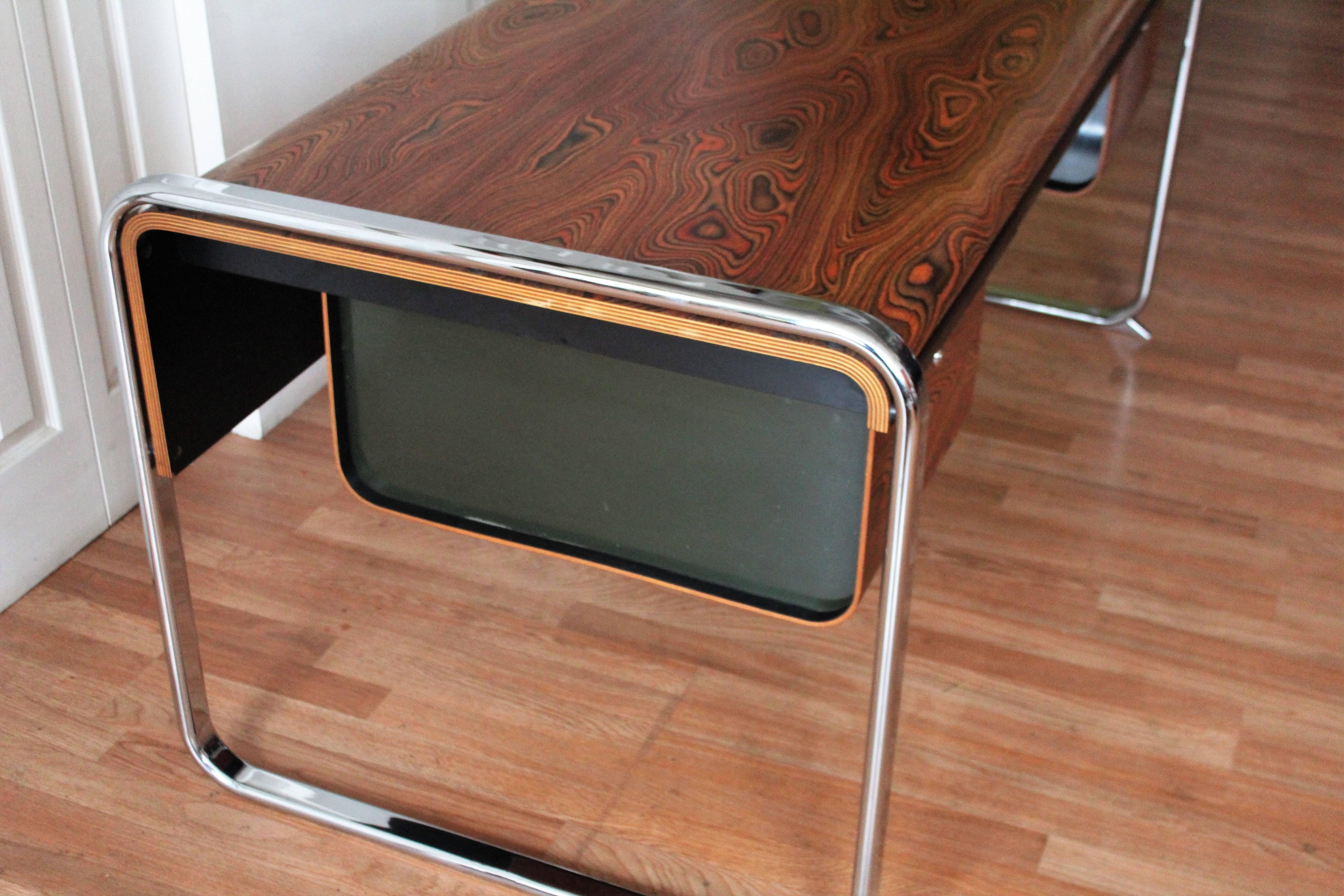 African Zebra wood desk designed by Peter Protzman for Herman Miller with a wrap around chrome frame. Theres a pull-out pencil drawer nestled in the middle and two black Lucite lined file drawers that flank both sides. Note: The Zebra wood is awe