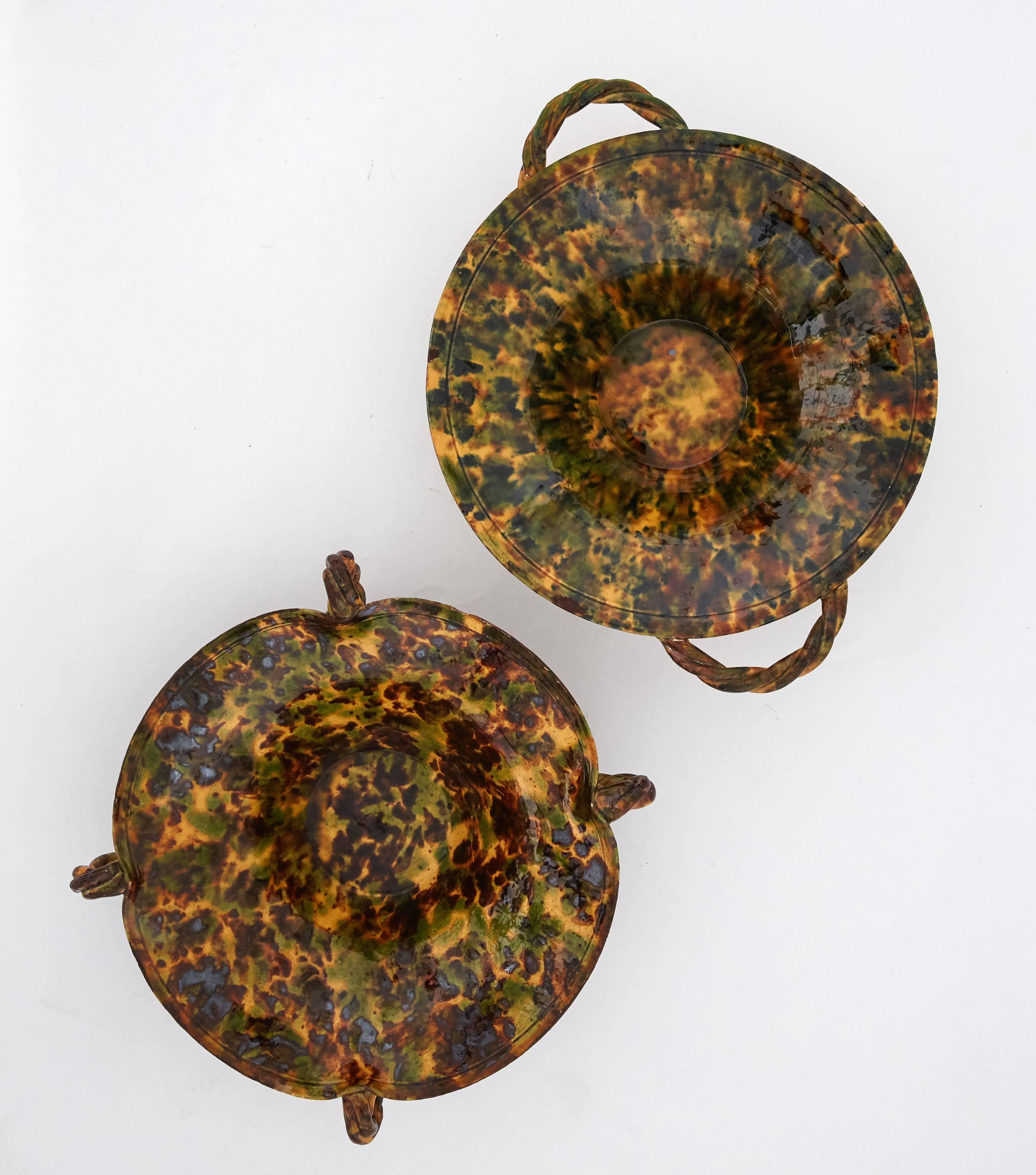 This pair of tortoise shell effect large ceramic bowls were made in France in the early 20th century. These beautiful large bowls are made in ceramic and embellished with a tortoise shell effect glaze. They were made in Provence in the early 1920s