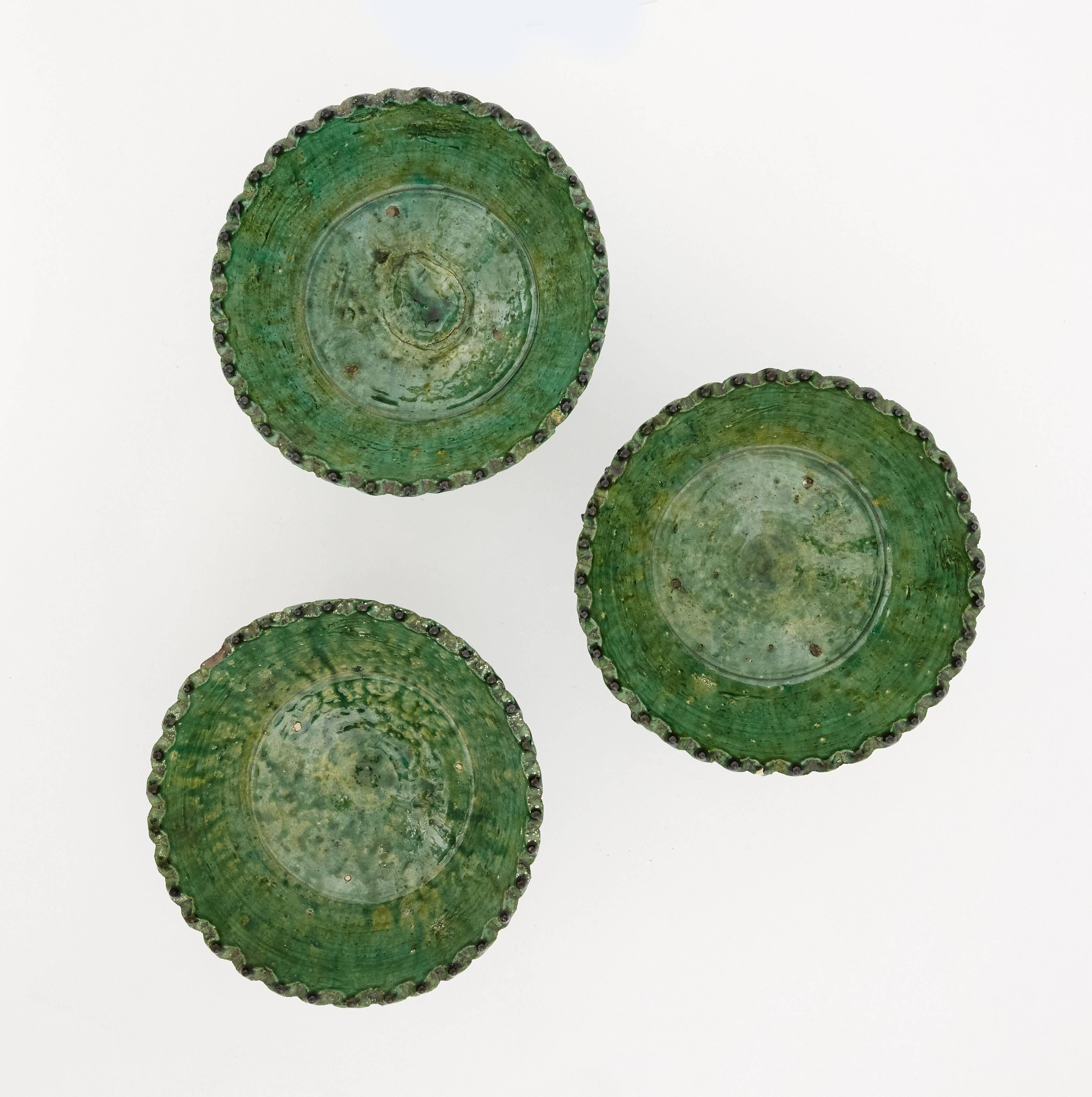 This set of three ivy green glazed ceramic bowls are handcrafted by a local craftman in Morocco. They have a beautifully organic structure which was carved by hand and glazed in a natural green finish. One of a kind pieces and perfect as ornamental