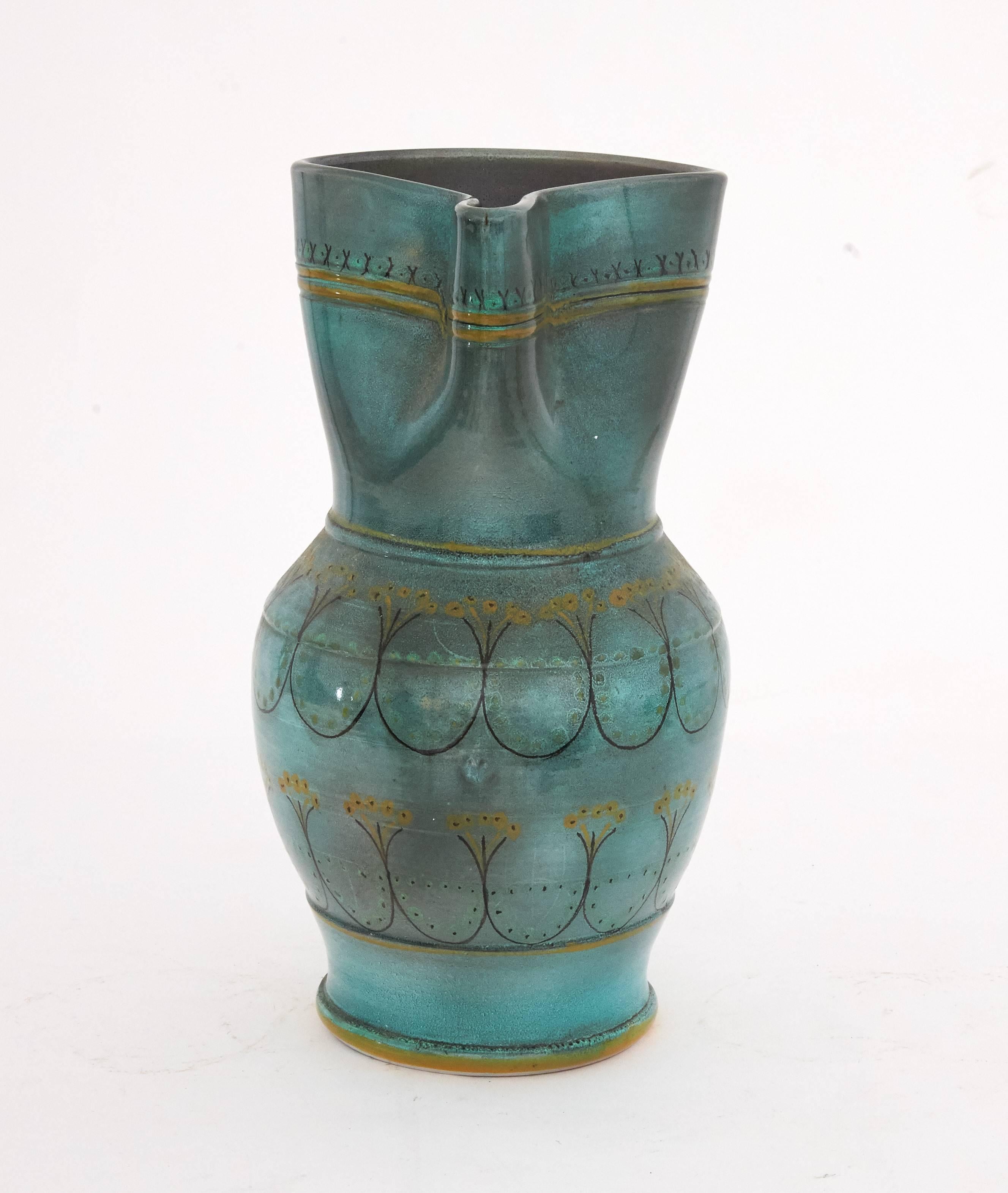 This very rare, large ceramic water pitcher is typical of Mediterranean pottery in the late 19th / early 20th century time. The pitcher was handcrafted and beautifully painted with muted greens, blues and greys, with circular patterns around the