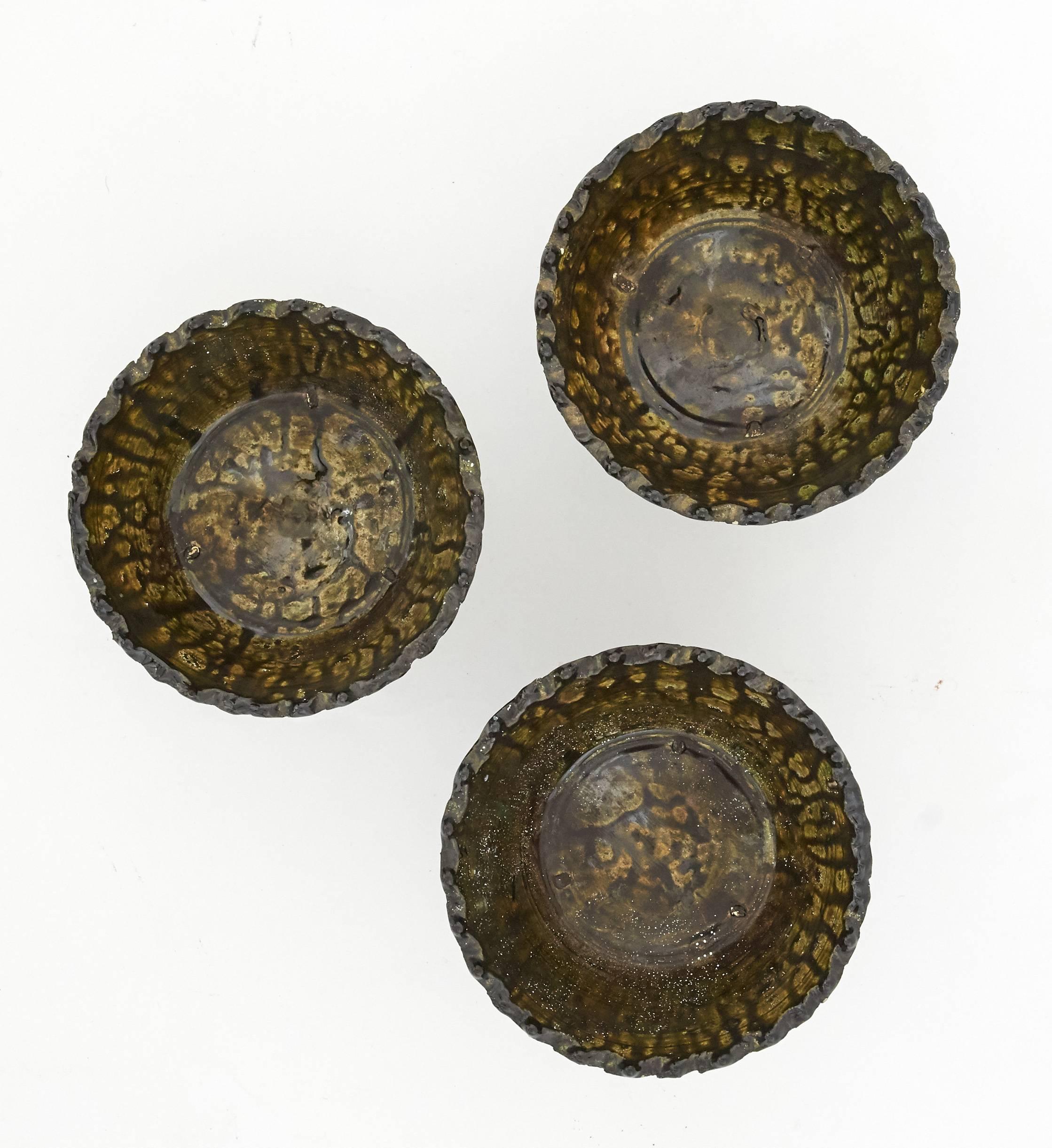 This set of moss green glazed ceramic bowls are handcrafted by a local craftsman in Morocco. They are carved into a beautifully organic structure by hand and glazed in a natural green finish. They are perfect as decorative objects or as serving